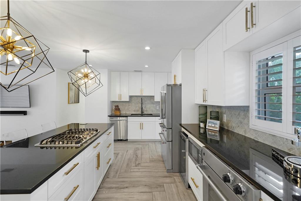 Must see custom-built home in the heart of Pompano Beach! Harbor village is one of the most desirable neighborhoods east of federal highway, zoned for airbnb, and of course only a few minutes from the golden beaches and restaurants. Newly constructed with heated pool + spa! This home is equipped with natural gas, impact doors, windows, and 2 car garage, fully fenced with automatic gate, metal roof and back-up generator. Bright airy rooms with an open concept floor plan boasts modern lighting, porcelain tiles, stainless steel appliances, and sleek cabinetry. Secluded master bedroom on the 2nd floor with private balcony provides ultimate tranquility. This is a must see, words can not describe how this home feels and looks in person! Perfect for a large family or people who love to entertain!