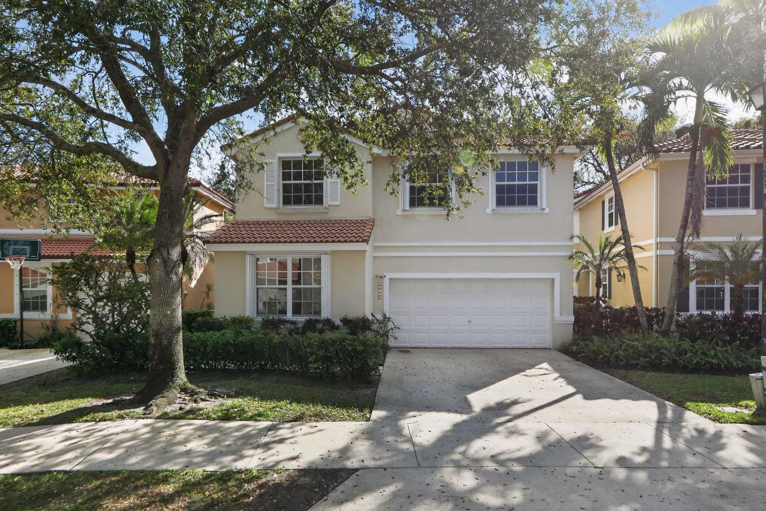 New roof under contract - enjoy peace of mind from day one. Welcome to this exceptional 4-bedroom, 2.5-bath Davie home featuring the largest floor plan in the community, with a den easily convertible into a 5th bedroom, located in a gated neighborhood with resort-style amenities. The moment you enter, you're greeted by dramatic 20-foot ceilings in the living room, creating a bright, open, and elegant atmosphere rarely found in homes at this price point.  The thoughtfully designed split primary bedroom floor plan offers flexibility, comfort, and separation of space. The fully fenced backyard is a true highlight, backing directly onto a 3-acre park - offering serene views, privacy, and no rear neighbors. Enjoy outdoor living year-round in the 27' x 9' screened enclosure, with ample room to add a pool while still maintaining green space.  Additional features include accordion hurricane shutters for peace of mind, a flexible den perfect for a home office, hobby room, fitness space, guest accommodations, or additional living area, and a layout designed for both everyday living and entertaining.  Situated in the Chelsea at Ivanhoe gated community with a community pool, this home combines space, security, and lifestyle in one of Davie's desirable locations. This is a rare opportunity to own the largest floor plan in the neighborhood, offering exceptional space, privacy, flexibility, and premium features - all just minutes from parks and major commuter routes.