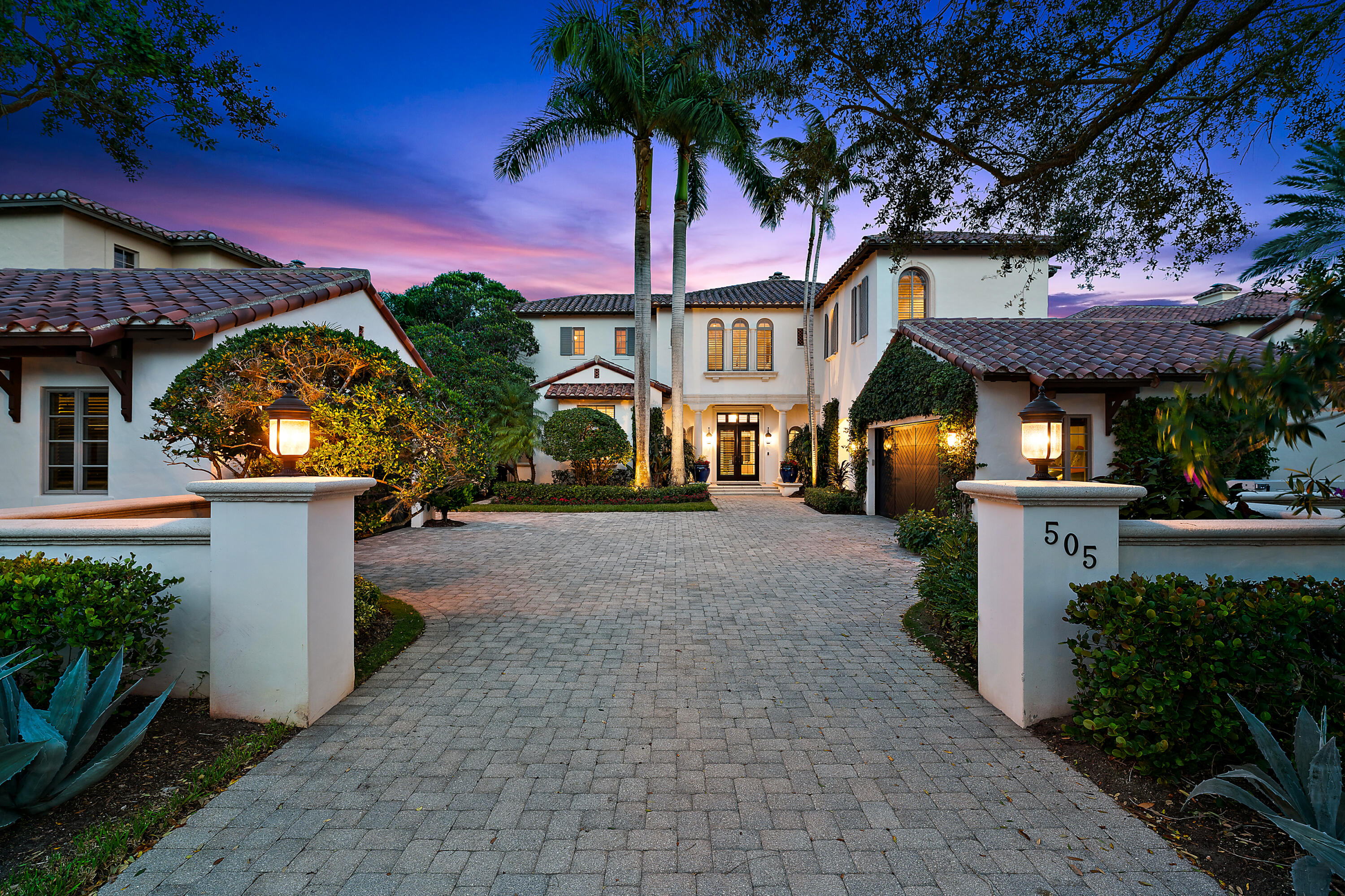 This elegant home, nestled in the sought-after estate section of the prestigious Trump National Golf Club, features 5 bedrooms and 6.5 bathrooms. The residence includes a recently updated gourmet chef's kitchen, a second-story bonus/media room, dual laundry facilities, office space, and four additional ensuite bedrooms. Notable features encompass a full private gym and a whole-home generator with a direct gas feed, ensuring uninterrupted power supply, along with fully motorized outdoor lanai screens and electric window treatments throughout. The spacious first-floor master wing offers oversized closet space. The secluded backyard oasis bordering the 8th green, showcases a heated pool, spa, and cabana bath for a private retreat. Conveniently located just minutes away from dining, shopping, entertainment, and pristine beaches, this home provides a luxurious lifestyle, further enhanced by a dedicated residential coordinator who performs full time concierge services for the home and its owners.