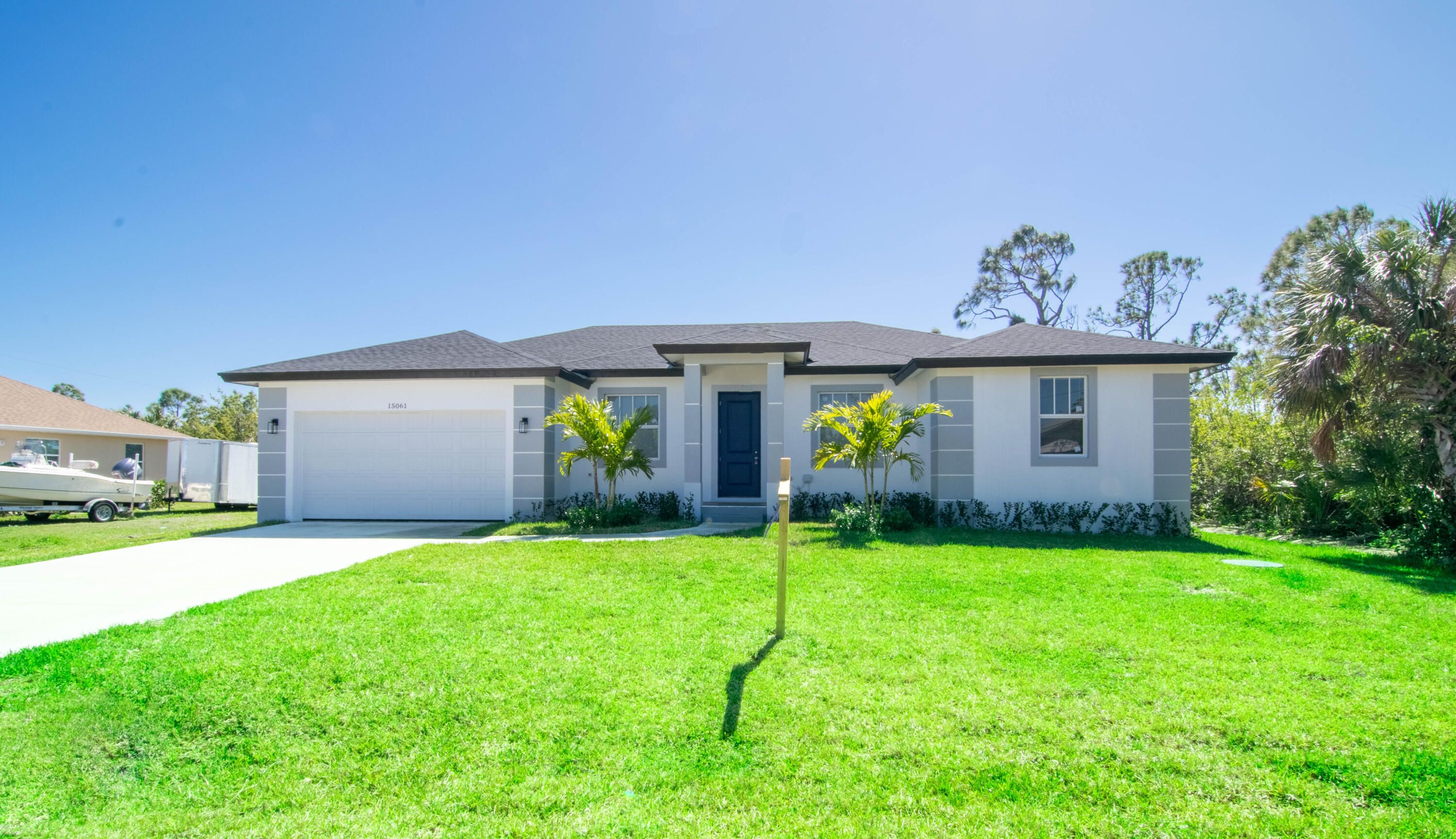 Single Family Home in Port Charlotte  This newly built gem blends modern design and functionality, offering spacious, sun-filled living areas. The kitchen features sleek white countertops, an island, and modern appliances—perfect for any home chef. Enjoy a peaceful, lush yard ideal for relaxation. Located just minutes from Gasparilla Road, this home offers the perfect balance of tranquility and convenience. Virtual staging for illustration purposes.