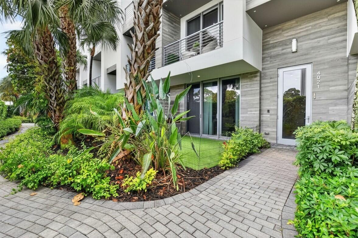 Modern luxury townhome in the highly sought-after Moderne Boca Raton gated community featuring 3 bedrooms, 3.5 baths, and a 2-car garage. This upgraded contemporary residence offers soaring ceilings, abundant natural light, and elevated designer finishes throughout. The stunning double-island kitchen showcases JennAir appliances, European cabinetry, quartz countertops, and custom lighting. A private first-floor bedroom with access to the fenced turf backyard is perfect for guests, office, or fitness space. The spacious primary suite features custom closets and a spa-inspired bath. Enjoy resort-style amenities including a luxury pool and fitness center. Prime East Boca location adjacent to Pondhawk Preserve and minutes from Mizner Park, Town Center, dining, shopping, and top-rated schools.