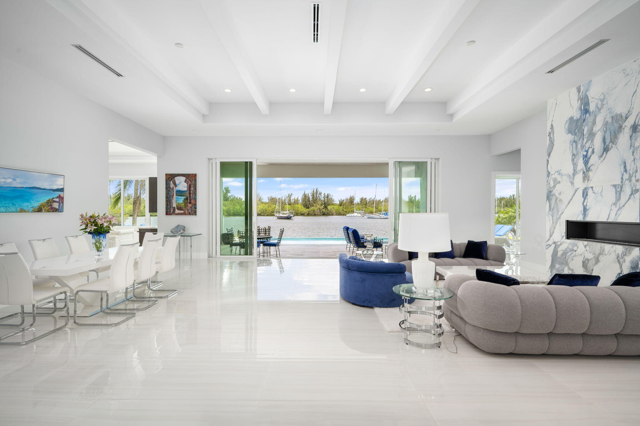 Luxury riverfront living in Vero Beach! Custom 2022 built home with 4 beds, 4 baths, 3 car garage, and 5,261 SF. Soaring ceilings and floor-to-ceiling sliders frame breathtaking river views, seamlessly connecting indoor and outdoor living. Chef's kitchen with quartz counters & premium Jenn-Air appliances, elegant living room gas fireplace, private saltwater pool and spa, dock with boat & jet-ski lifts, and 109 feet of river frontage. Meticulously crafted riverfront retreat offering ultimate luxury, style, and waterfront lifestyle, perfect for entertaining and boating enthusiasts.