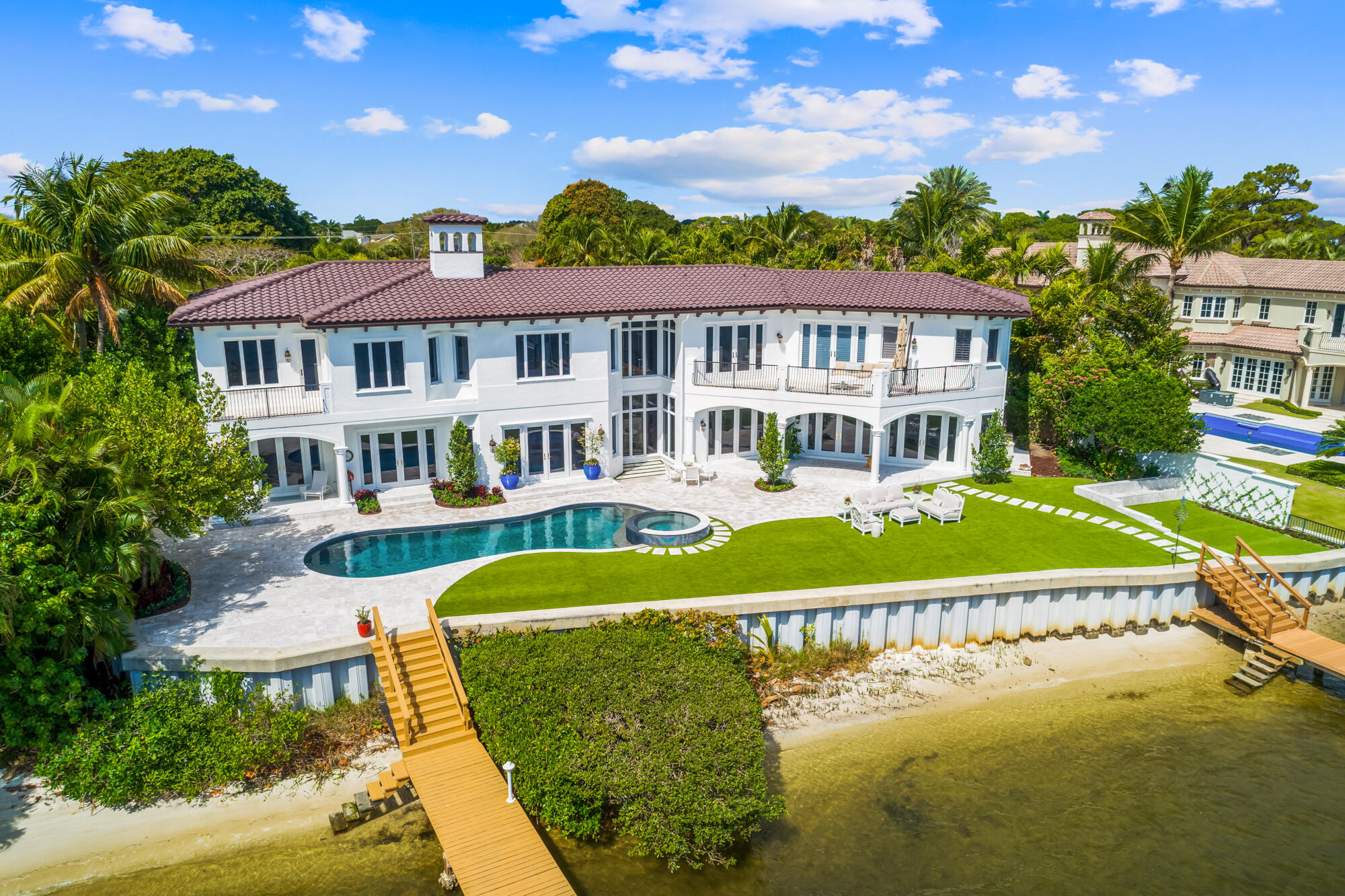 ULTIMATE LUXURY - 1.5 ACRE - 140' RIVERFRONT - PRIVATE ESTATE W/ DOUBLE GATED PRIVATE ENTRIES - DOUBLE DOCK & 3 LIFTS - TENNIS COURTS!!!!!  This Newly renconstructed transitional custom estate situated on 1.5 acres with 140 ft directly on the Loxahatchee River in Tequesta. This luxury waterfront property boasts over 10,000+ total sq ft including 5 bedrooms, 6.1 baths, 6 car garage, with detached guest house, private tennis court and 2 gated entries for complete privacy.  
The custom Downsview kitchen with an oversized island, luxurious Cristallo counters, Subzero refrigerator/freezer, pocketed pantry, La Cornue gas range, Miele coffee maker, 2 dishwashes and oversized kitchen sink. A private wine room with 300 bottled wine refrigeration, custom walls & shelving and custom barn doors. There are two master suites: one on main floor and one upstairs that will make your jaw drop.   The upstairs master suite features separate his and her baths with her own 400 sq ft custom closet with special lighting and much more.  Some other new features include brand new fully automated smart house system, with Vantage Control System, newly automated gates, all new bathrooms with Toto water closets with Neorest cyclone flush system, brand new landscaping in front and back yard that includes new garden, new hedges, jasmine on diamond, bougainvillea flowers, backyard with new marble pavers, new synthetic turf, new saltwater pool system with new pool equipment, pool pump and propane heater and much more.  The owner spared no expense on the transformation of this incredibly meticulous estate which offers unparallel construction quality and ultimate privacy with panoramic river views.

With sweeping views of the river from almost every room, this property is truly a boater's paradise with 2 boat docks & 3 lifts (one for 30K lbs & two for 10K lbs) on prestigious Anchorage Point along the Loxahatchee River!  Only 10 minutes from Jupiter Inlet, Anchorage Point is Tequesta's best kept secret. It offers its residents a spectacular lifestyle including close proximity to secluded & pristine beaches, great fishing and snorkeling, excellent schools, worlds best restaurants, nearby world class shopping and so much more.