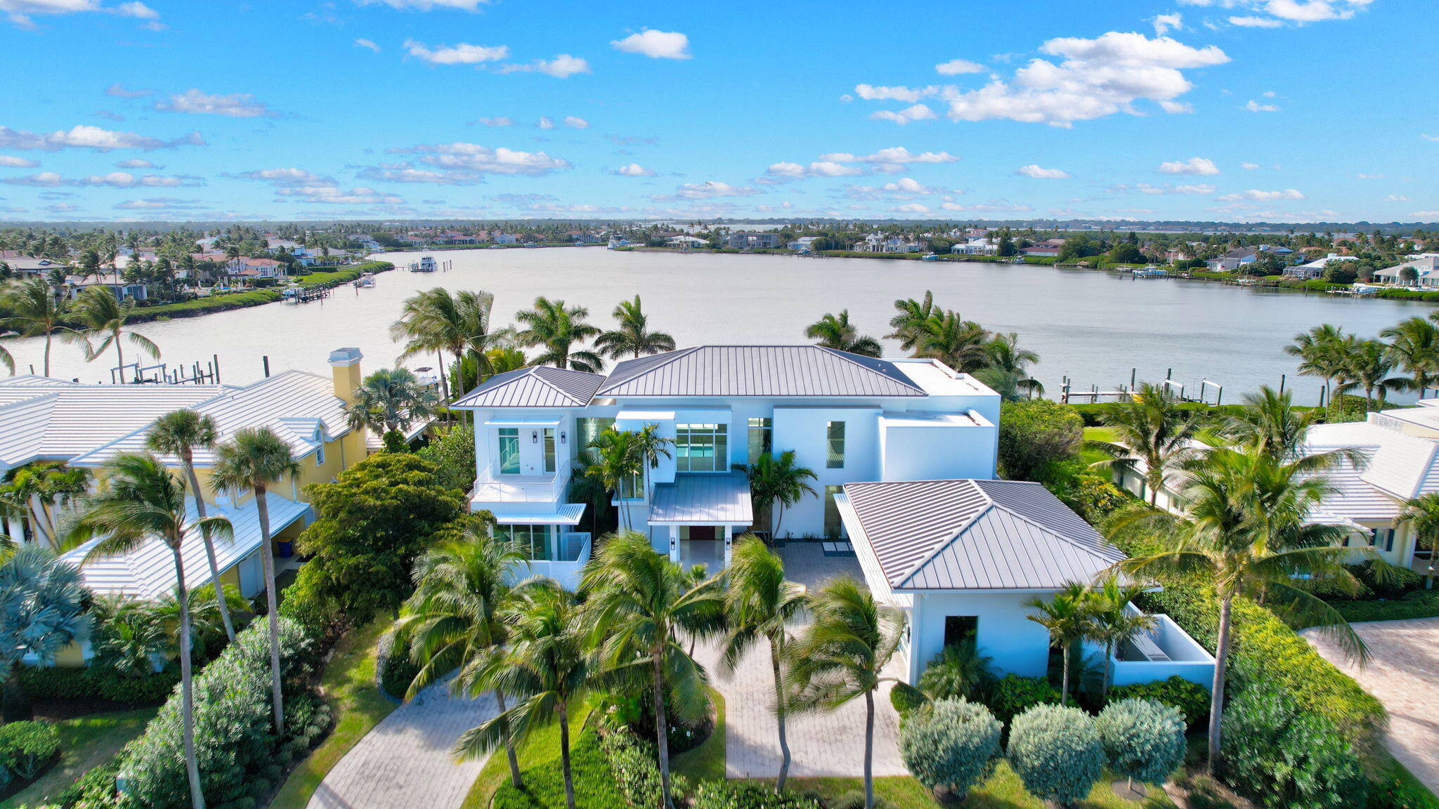 Experience the best of luxury living in this waterfront coastal contemporary estate in the prestigious community of Sailfish Point. An exceptional opportunity for boating enthusiasts with 125ft of water frontage, an expansive deepwater dock that may accommodate 3 large boats and minutes to ocean access. The exquisite architectural masterpiece, built in 2021, was designed for privacy and refined elegance. Soaring ceilings, walls of glass, and meticulous attention to detail create a bright inviting atmosphere ideal for both entertaining and everyday living. Sailfish Point offers the ultimate Florida resort lifestyle with its oceanfront country club, fine and casual dining, HydroGrid tennis, pickleball, Jack Nicklaus 'Signature' no tee time golf course, state-of-the-art fitness center and spa, helipad, 1.5 miles of gorgeous beach, full-service marina and the ultimate in private security. Sailfish Point is also located within minutes of Witham Field, suitable for landing large private aircraft with US Customs on-site.