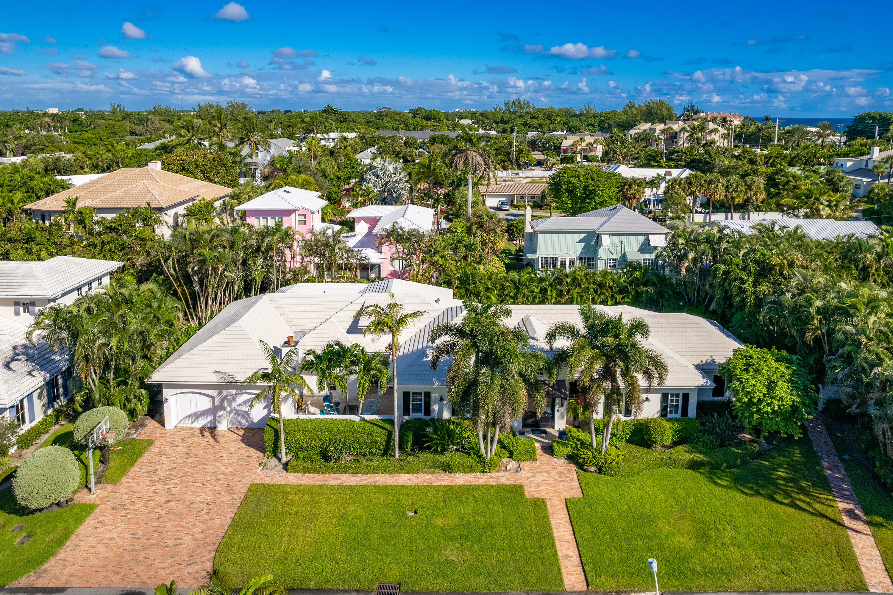 Stunning home on oversized lot. Private beach access! This gem was completely rebuilt in 2011, and updated this year including an all-new gourmet chef's kitchen and addition of guest suite with lush private patio. Surrounding the redesigned chef's kitchen, the living, dining and family areas boast an open layout with vaulted wood panel ceilings. A large master and 4 well situated guest suites provide ample space for family and friends. The home features truly unique outdoor space for entertaining or relaxing. The courtyard with wood burning fireplace is perfect for cozy winter nights. Over-looking the tropical grounds, heated pool and spa is an inviting loggia complete with summer kitchen, wet bar, and tv. Perfect for enjoying the South Florida lifestyle, this home is situated in a highly desirable area less than a mile from Atlantic Avenue and steps from the beach.