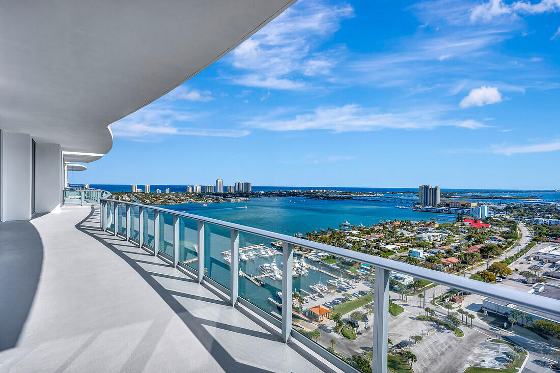 Welcome to Nautilus 220, a beautiful penthouse Sky Suite with high ceilings, a grand entrance, and an open floor plan that naturally lights up with direct southeast views of both the intracoastal and the ocean, offering expansive views of Singer Island stretching to Palm Beach inlet. Enjoy the relaxation of this large, comfortable, contemporary split-floor plan, featuring a balcony offering beautiful sunrises every morning.