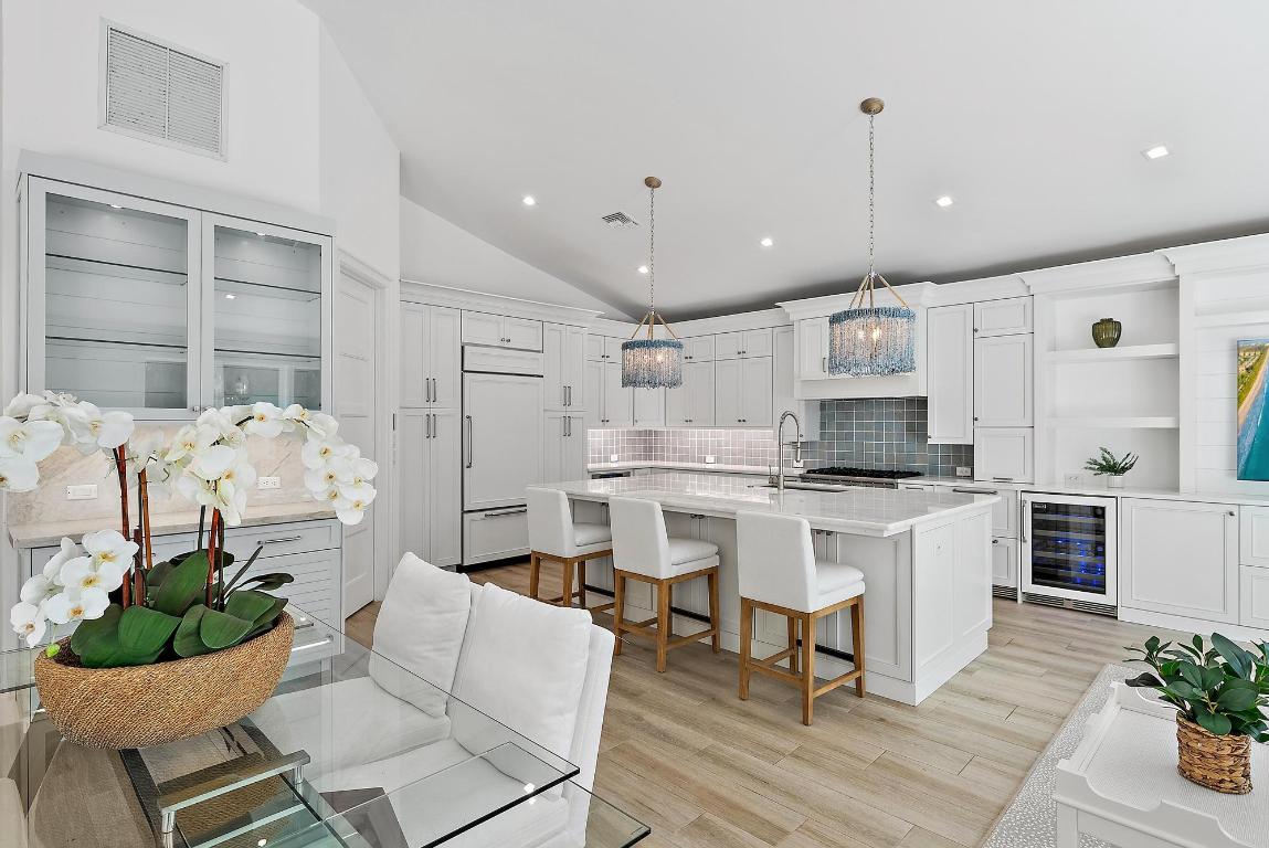 Enjoy your morning coffee and stroll to the beach. This elegant 3-bedroom, 3.5-bath home in the exclusive Jupiter Inlet Colony captures the essence of refined coastal living, where timeless design meets modern comfort.  Soaring cathedral ceilings draw in abundant natural light, lending the open interiors an airy, inviting atmosphere. Stackable sliders open completely to the covered patio and heated pool, blending indoor and outdoor spaces for the ultimate coastal lifestyle — perfect for entertaining or relaxing in privacy. The chef-inspired kitchen is a true centerpiece, featuring a lighted marble island, custom cabinetry, premium gas appliances, and designer finishes that combine function with beauty. Every detail throughout the home has been thoughtfully curated   from the bespoke built-ins and wallpaper accents to elegant lighting and window treatments.  Outdoors, lush tropical landscaping, ambient lighting, and a mosquito control system make every evening feel like a getaway.  Nestled within one of Jupiter's most prestigious seaside enclaves, residents of Jupiter Inlet Colony enjoy private beach access, an optional Beach Club membership, a private marina and yacht club, and a dedicated community police department   offering luxury, serenity, and peace of mind in one of South Florida's most desirable coastal settings.Modern Enhancements: Recent upgrades include a brand-new garage door (3/24) and water heater (3/24), ensuring effortless comfort and reliability. Generous Dimensions: 2,654 sq. ft. under air and 3,374 sq. ft. total, situated on an expansive 105 x 90 lot. 240 single-family residences offers unparalleled privacy and exclusivity. Residents enjoy access to pristine, sun-drenched beaches and a wealth of lifestyle amenities, including: An optional Beach Club membership for social gatherings and relaxation. A private marina and yacht club, ideal for boating enthusiasts. A dedicated community police department for added peace of mind. Additional Up-Grades: Kitchen: Larger Island (including larger sink) New appliances: refrigerator, dishwasher, wine cooler, refrigerated drawers Lighted marble island countertop Countertops Backsplash Island sconces Custom built in Bar with lighting Custom Built ins with bookshelves and drawers Wallpaper Hardware Draperies and Shades  Laundry Room: Washer/Dryer Custom built ins Hardware  Living Room/Entry: Chandlier Shiplap Drapes  Powder Room: Custom built ins Mirror Scounces Wallpaper Counter top Faucet Toto toilet Hardware  Bobby Bedroom/Bathroom: Closet built ins Draperies/shades  Wallpaper Shower Door Toto Toilet Roeburn medicine cabinet  Mia's Bedroom: Chandlier Wallpaper Draperies/Shades  Mia's Bathroom: Built Ins Mirror Wallpaper Plantation Shutter Faucet Toto toilet Countertop  Master Bedroom: Closet CA Closets Wallpaper Draperies  Master Bathroom: Wallpaper Built Ins Hardware Marble Countertop Faucet Toto toilet Shower door Water Heater Scounces Mirror Robern Medicine Cabinet  Garage: Floor Built In Cabinets Insulation Tankless Water Heater Split A/C Garage Door Hot water sink  Outside: Lighting on front of house Pavers on side of house Mosquito System Two a/c units Ceiling fan Back porch wicker chandeliers
