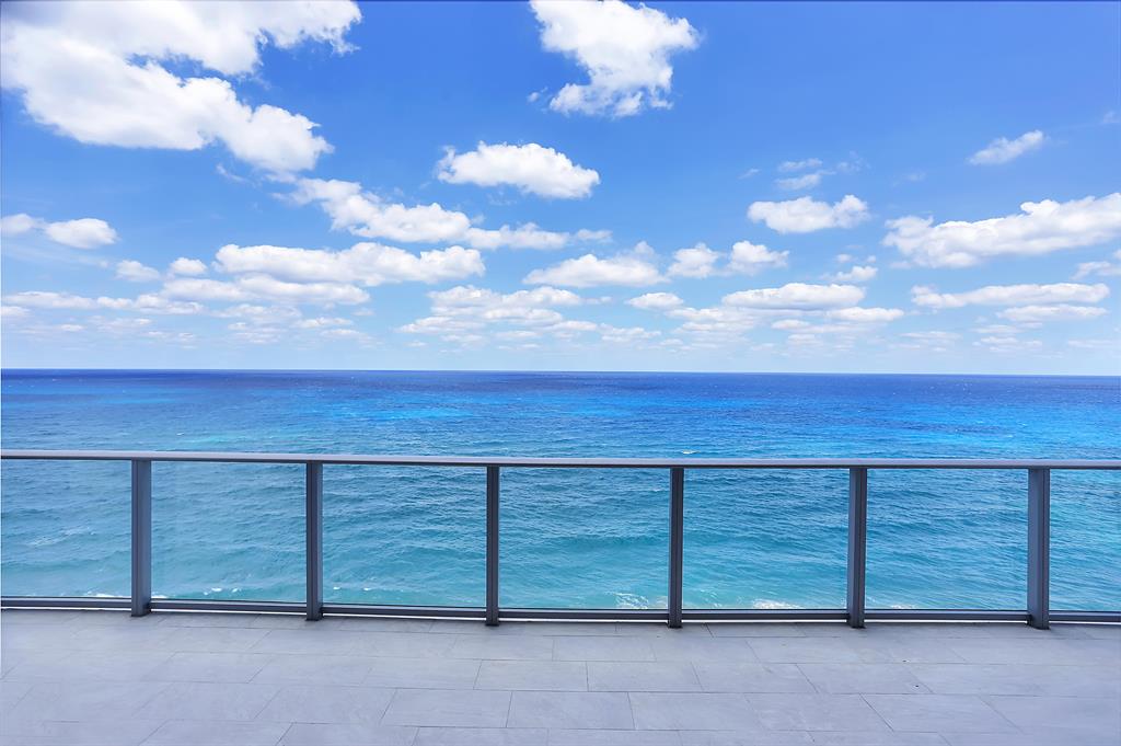 Welcome to next-level luxury in this rare 2-story, direct oceanfront residence with 4 beds, 4.5 baths, 4,897 interior sq. ft. and family room. As one of only 48 residences at the newly completed boutique 5000 North Ocean, a private elevator entrance reveals ocean views through a soaring 20' high glass wall. You will love the expansive terrace overlooking direct views of the ocean and 345' of Singer Island beachfront. Includes three assigned garaged parking spaces & climate controlled storage locker. 5000 North Ocean provides a gracious lobby with full time reception & concierge services, club room, state-of the art fitness center, south facing oceanfront pool with sun all day, a secluded beach & cabana with fireplaces for entertaining. Pet friendly. Others Available. Beautifully finished and delivered furniture-ready with designer coordinated selections. Expansive walls of glass, innovative architectural designs and crisp modern interiors combine to create an unprecedented coastal lifestyle.
Elegant, large format porcelain flooring (24X48) throughout with 8' solid core interior doors.
The designer kitchen features European cabinetry with the latest storage systems and integrated LED lighting. A large Quartz island with waterfall edges, Pure White Quartz countertops and full-height backsplashes. Thermador appliances include a 30' refrigerator and 18" freezer column, gourmet 5-burner GAS-cooktop with 36" retractable stainless-steel canopy hood, under-counter microwave drawer, double wall ovens with warming drawer. The bar area provides both a wine cooler & beverage center. The second floor also has a bar area with sink, dishwasher, and beverage center.
Owner's suite includes expansive closet space. The bath finishes incorporate Lux High Gloss White European cabinetry, Mystery White marble countertop, with Grohe fixtures, Kohler sinks, and Toto toilets. Guest baths appointed with same level finishes.
There are two laundry rooms both upstairs and downstairs with upper & lower European cabinets with large capacity Electrolux front load washer & dryer.
Truly a unique property with significant space flexibility, including an elevator that is accessible from both floors.