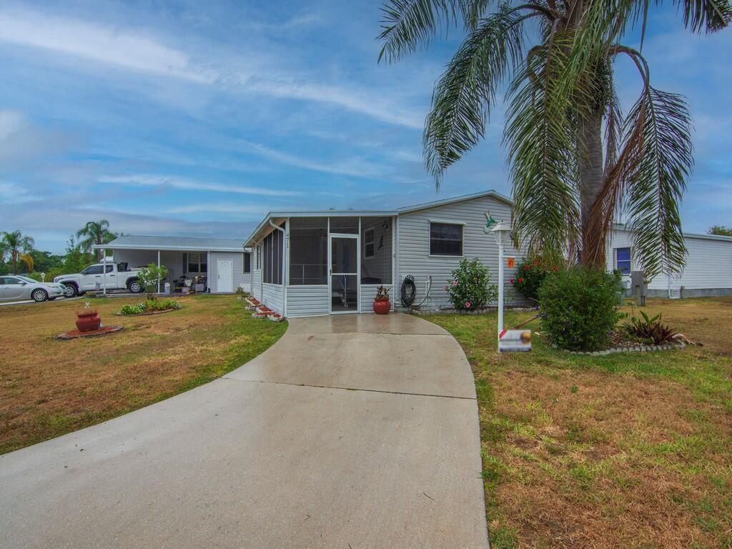 Lovely mobile home in a 55+ community. TURN KEY! This home is located in a quiet and peaceful neighborhood.  The home features 1 bedroom plus den/office, could easily be a second bedroom, cozy living room that opens up to the dining area.  Huge kitchen with lots of cabinet space.  Spacious bedroom with large Walk-in closet and full bathroom.  Screened patio, private storage, newer roof and newer AC.  Shutters and much more.  Buyer to verify measurements