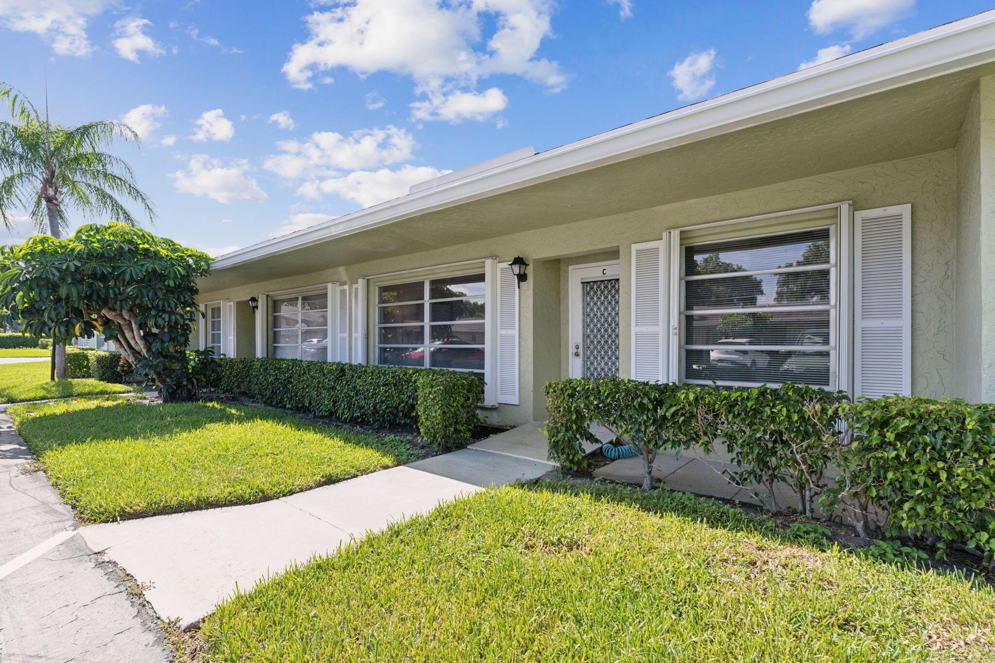 Welcome to your perfect South Florida retreat located in Active Adult Community. Stylishly updated 2 bedroom, 2 bath villa ANNUAL rental. Situated in a quiet, private setting, this home offers comfort, style, and accessibility. Spacious open floor plan with modern finishes. Fully equipped kitchen with updated appliances. Enjoy the enclosed patio, perfect for relaxing or entertaining Tastefully furnished with everything you need to move right in. ADA compliant for ease and accessibility with private entrance and peaceful surroundings.  Parking space right in front of unit. If you're looking for an fully furnished annual lease, this villa checks all the boxes. Conveniently located near shopping, dining, and just minutes to the beach. Pines has 2 clubhouses, 2 pools and fitness center.