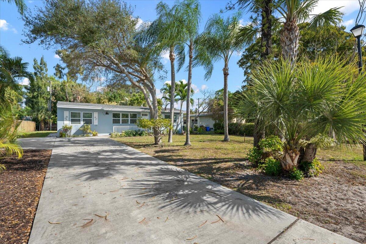 Charming 3-bedroom, 2-bath home in Lake Park, Florida, featuring a new roof and newer A/C system and full impact windows for peace of mind. The interior has been beautifully updated with a new kitchen and bathrooms, including white shaker cabinets, tile backsplash, and stainless steel appliances. Luxury vinyl wood flooring flows throughout the home, while designer tiles add elegance to the bathrooms. Enjoy the large, open yard with no HOA restrictions--perfect for outdoor living and entertaining. Don't miss this incredible opportunity--homes like this move fast!