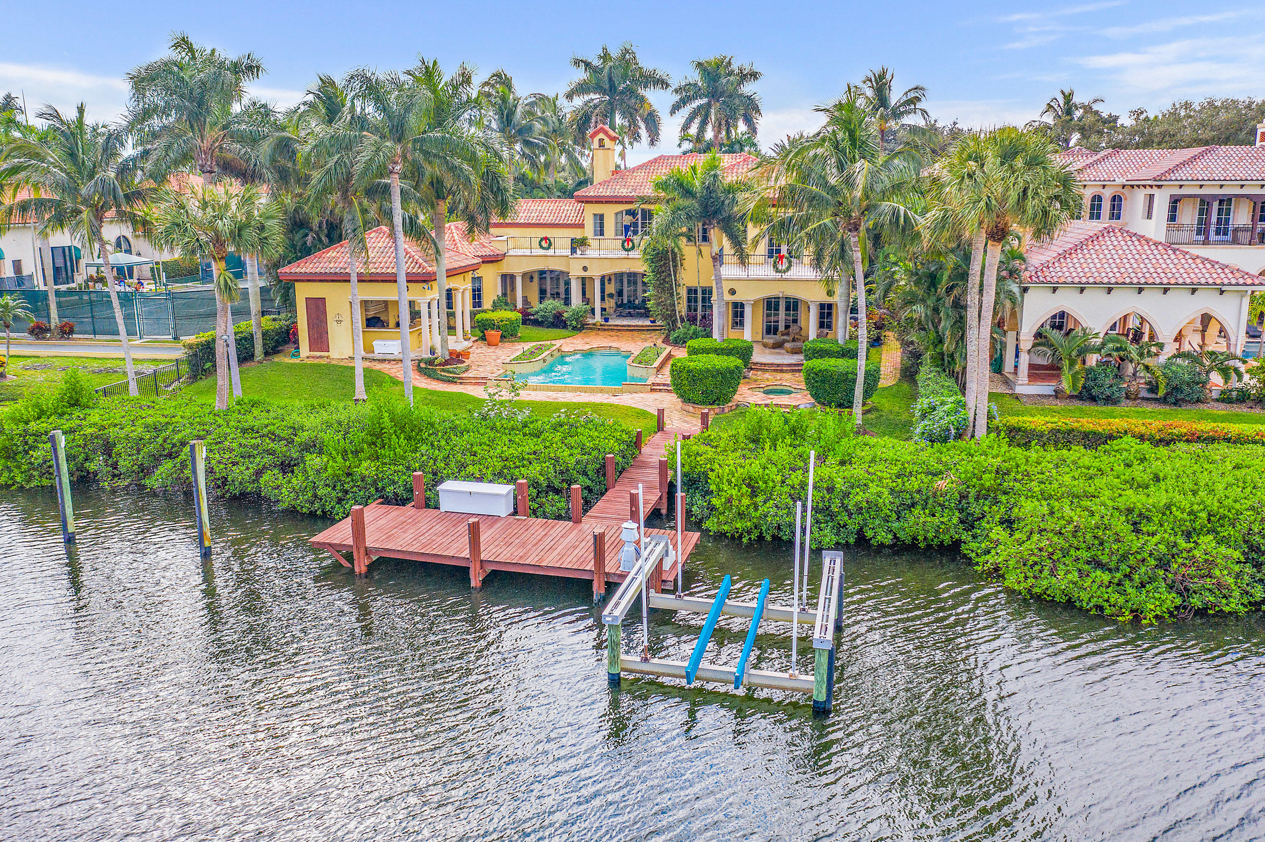 This grand estate home in the intimate community of Sawfish Bay has stunning Intracoastal views.  Situated on 100 feet of water frontage you will spend endless hours watching the mesmerizing boat activity.  The home boats 5 bedrooms, an office, open kitchen to the family room, a formal living room and formal dining room.  For the car enthusiasts there are garage spaces for 6 cars with 3 of the bays in it's own building.   Amazing opportunity  - this won't last.