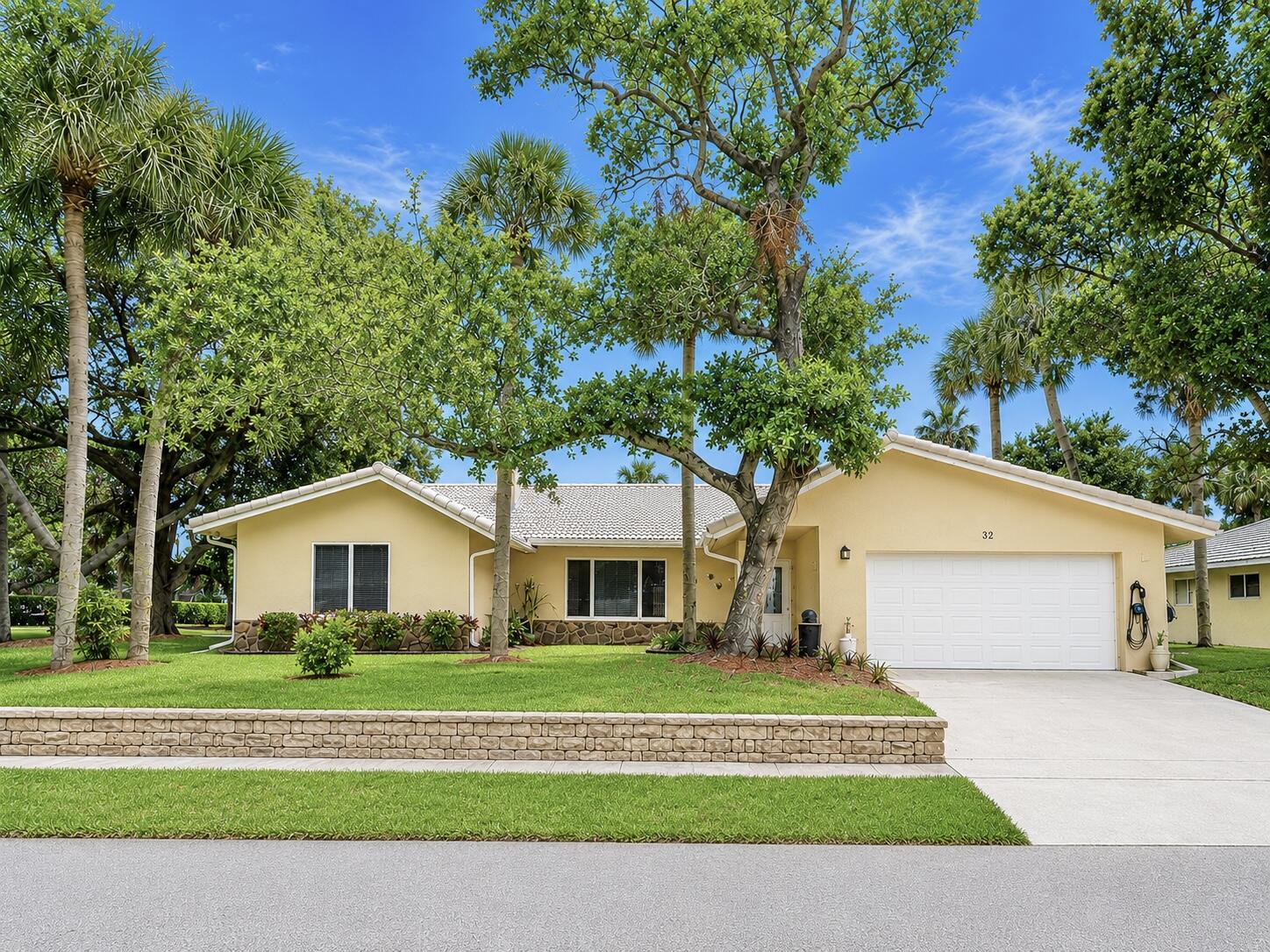 COMING SOON! Discover exceptional Florida living in this beautifully updated pool home, perfectly situated on a private corner lot at the end of a quiet cul de sac with NO HOA. Located just minutes from I95, Boca Raton's pristine beaches, Mizner Park, Brightline, premier shopping, dining, and entertainment, this home combines an unbeatable location with over $200,000 in quality improvements.  Every detail has been carefully curated to create a home that is as functional as it is beautiful. Soaring vaulted ceilings, abundant natural light, LED lighting throughout, and an inviting open layout create a warm yet sophisticated atmosphere from the moment you enter. The home offers multiple gathering spaces, including an elegant sunken living room with a wood burning fireplace and a spacious  family room designed for effortless everyday living and entertaining. At the heart of the home is the stunning chef's kitchen, completely redesigned in 2021 to seamlessly blend style and function. Anchored by a large Cambria quartz island, the space features stainless steel appliances, an induction cooktop, custom cabinetry, and generous prep space, making it equally suited for intimate dinners or hosting family and friends. This master bedroom serves as a true retreat. The spacious bedroom offers direct access to the Florida room and features three separate closets, including a walk in closet, a wall closet, and an additional linen closet, providing exceptional storage and organization. The master bathroom was fully renovated within the past year, showcasing dual vanities, a Toto toilet, a beautifully designed walk in shower, and convenient cabana access for the pool. The guest bathroom has also been completely remodeled with timeless finishes and features a custom locking barn door. Every bedroom received new carpeting in 2021, completing the home's move in ready appeal. Designed to embrace South Florida's indoor outdoor lifestyle, the backyard is nothing short of spectacular. A sparkling saltwater pool is surrounded by an expansive travertine deck, creating the perfect setting for entertaining or quiet relaxation. Two custom pergolas define the outdoor living experience. One houses a fully equipped outdoor kitchen featuring both gas and charcoal grills, an outdoor refrigerator, generous countertop space, and everything needed to entertain with ease. The second pergola offers an inviting covered lounge area, creating another destination to gather with family and guests. Surrounded by lush tropical landscaping, the fully fenced backyard feels like a private resort. The modern horizontal wood privacy fence, installed approximately two years ago, is enhanced with low voltage landscape lighting and gate access on both sides of the home. Mature fruit trees and tropical plantings, including lime, cherry, two mango trees, ginger, two banana plants, and kumquat, add beauty and character to this exceptional outdoor oasis. Additional features include impact glass throughout, a tile roof approximately ten years old, a 2021 water heater, two newer air conditioning systems, and an automatic six zone irrigation system. Offering timeless updates, exceptional outdoor living, and an unbeatable Boca Raton location, this is more than a home. It is a private retreat designed for those who appreciate quality, comfort, and the very best of South Florida living.  (Professional photos, aerials, drone, matterport, floorplan and walk-through video coming soon)