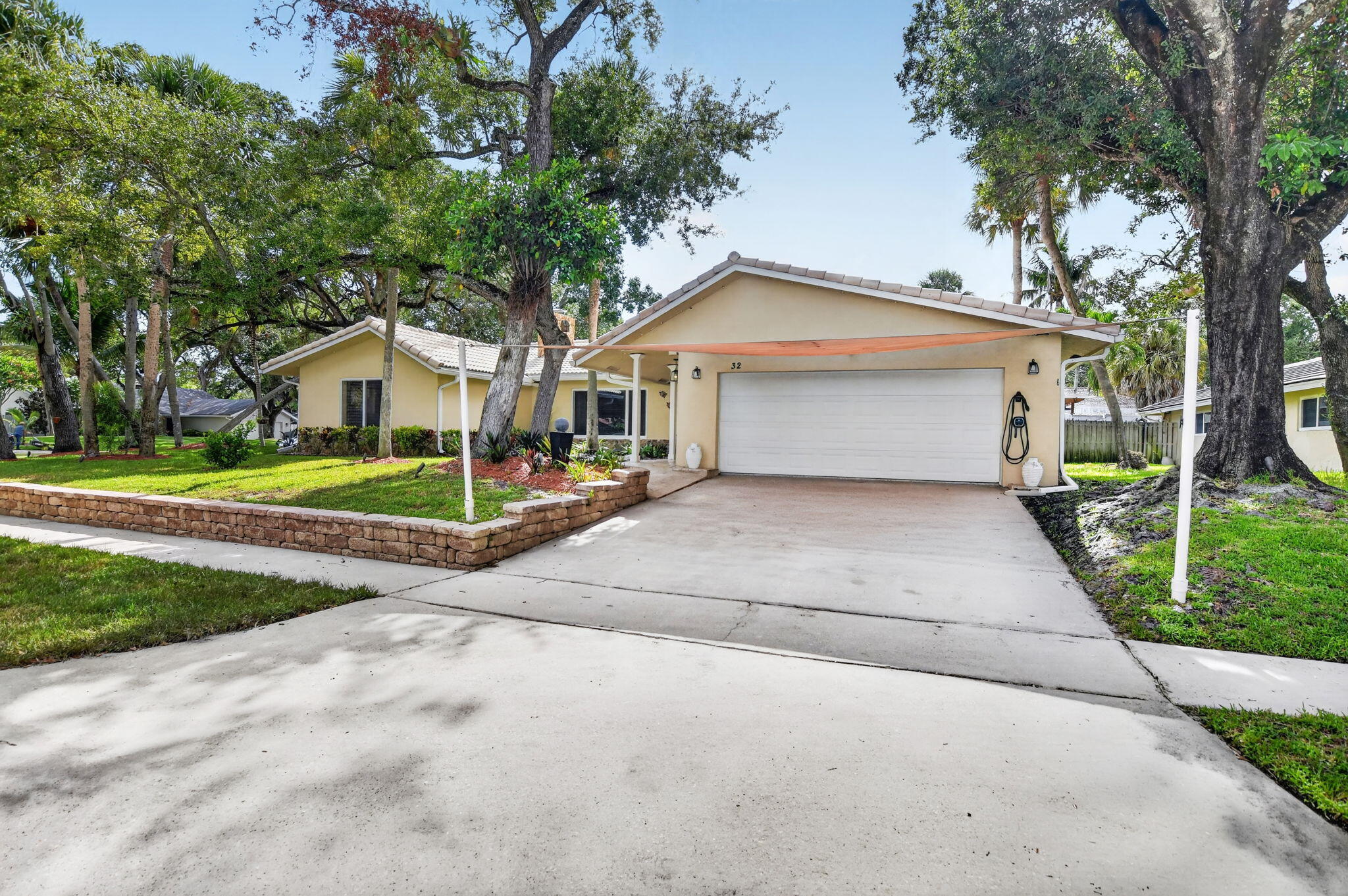 Discover exceptional Florida living in this beautifully updated pool home, perfectly situated on a private corner lot at the end of a quiet cul de sac with NO HOA. Located just minutes from I95, Boca Raton's pristine beaches, Mizner Park, Brightline, premier shopping, dining, and entertainment, this home combines an unbeatable location with over $200,000 in quality improvements.  Every detail has been carefully curated to create a home that is as functional as it is beautiful. Soaring vaulted ceilings, abundant natural light, LED lighting throughout, and an inviting open layout create a warm yet sophisticated atmosphere from the moment you enter. The home offers multiple gathering spaces, including an elegant sunken living room with a wood burning fireplace and a spacious  family room designed for effortless everyday living and entertaining. At the heart of the home is the stunning chef's kitchen, completely redesigned in 2021 to seamlessly blend style and function. Anchored by a large Cambria quartz island, the space features stainless steel appliances, an induction cooktop, custom cabinetry, and generous prep space, making it equally suited for intimate dinners or hosting family and friends. This master bedroom serves as a true retreat. The spacious bedroom offers direct access to the Florida room and features three separate closets, including a walk in closet, a wall closet, and an additional linen closet, providing exceptional storage and organization. The master bathroom was fully renovated within the past year, showcasing dual vanities, a Toto toilet, a beautifully designed walk in shower, and convenient cabana access for the pool. The guest bathroom has also been completely remodeled with timeless finishes and features a custom locking barn door. Every bedroom received new carpeting in 2021, completing the home's move in ready appeal. Designed to embrace South Florida's indoor outdoor lifestyle, the backyard is nothing short of spectacular. A sparkling saltwater pool is surrounded by an expansive travertine deck, creating the perfect setting for entertaining or quiet relaxation. Two custom pergolas define the outdoor living experience. One houses a fully equipped outdoor kitchen featuring both gas and charcoal grills, an outdoor refrigerator, generous countertop space, and everything needed to entertain with ease. The second pergola offers an inviting covered lounge area, creating another destination to gather with family and guests. Surrounded by lush tropical landscaping, the fully fenced backyard feels like a private resort. The modern horizontal wood privacy fence, installed approximately two years ago, is enhanced with low voltage landscape lighting and gate access on both sides of the home. Mature fruit trees and tropical plantings, including lime, cherry, two mango trees, ginger, two banana plants, and kumquat, add beauty and character to this exceptional outdoor oasis. Additional features include impact glass throughout, a tile roof approximately ten years old, a 2021 water heater, two newer air conditioning systems, and an automatic six zone irrigation system. Offering timeless updates, exceptional outdoor living, and an unbeatable Boca Raton location, this is more than a home. It is a private retreat designed for those who appreciate quality, comfort, and the very best of South Florida living.  (Professional photos, aerials, drone, matterport, floorplan and walk-through video coming soon)
