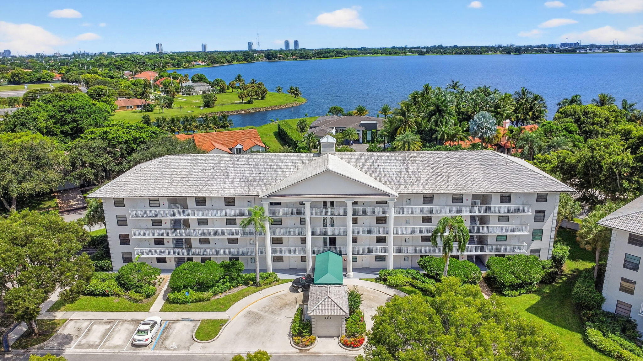 Enjoy the lake views from this corner-unit condo in a gated community. The desirable corner location offers added privacy. The interior features newly removed popcorn ceilings, attractive laminate flooring throughout, impact windows and an open-concept layout that connects the kitchen, dining, and living areas. The kitchen includes a newer refrigerator and granite counters, and the home includes a newer washer and dryer. An extra room next to the laundry area provides space for a home office, a hobby room, or storage. The condo has been tastefully decorated and can be offered furnished. The community is located next to shopping and dining, close to beaches, and near downtown WPB. Don't miss the chance to own this lakefront home in one of the area's most convenient and desirable locations.  Access from Congress, all realtors are allowed, the client must follow, easy to show, roof assessment has been paid in full by the seller