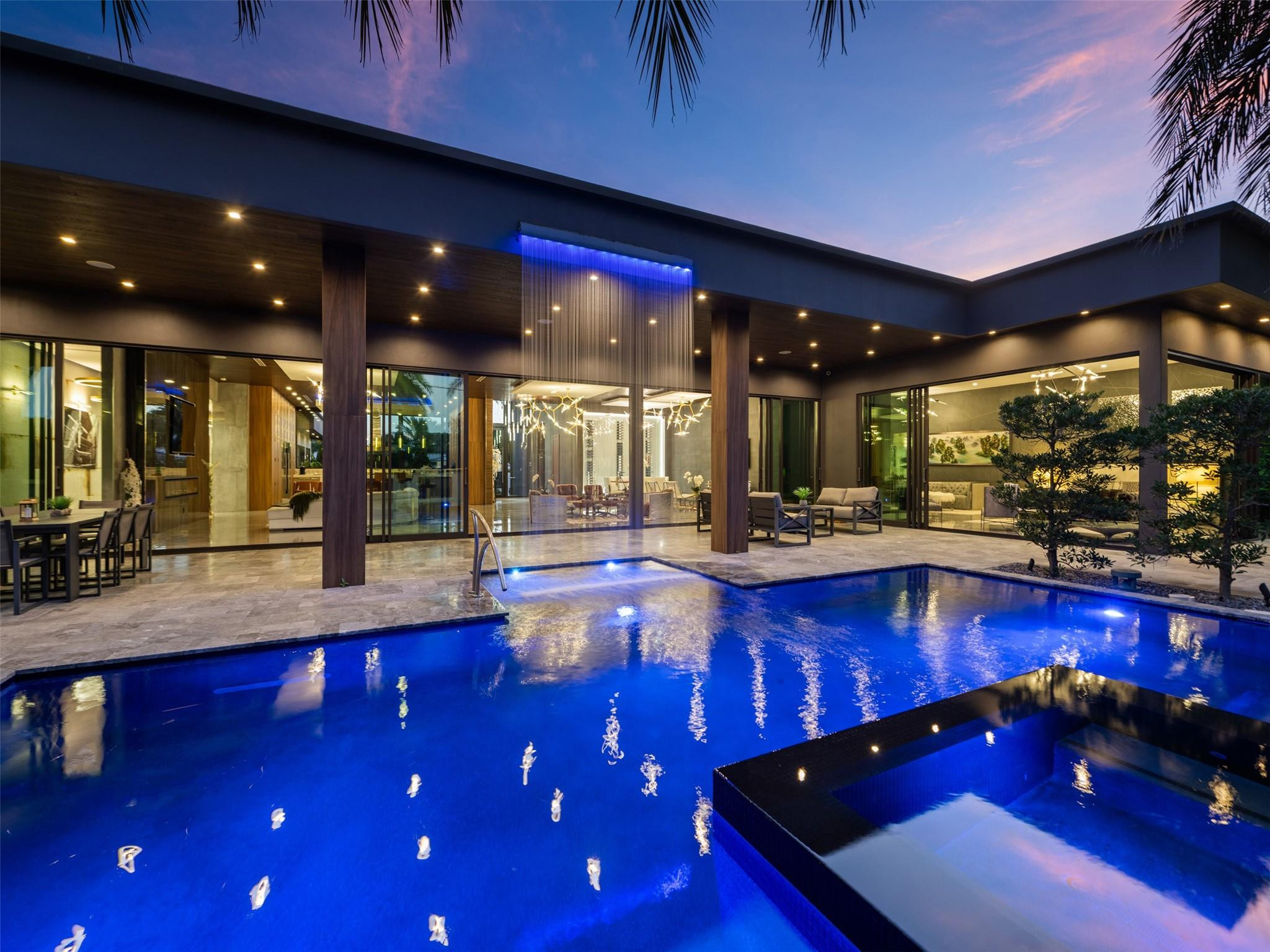 Designed & built by Prestige Design Homes,this turn-key estate is a standout example of their iconic residential work. The residence emphasizes superior craftsmanship, premium materials, innovative design, personalized features that blend functionality with opulence. Sited on a massive 21,000+ sq ft lot in Coral Ridge Country Club Estates, home is adjacent to a park & the golf course. With a 7,846 sq ft footprint, an open floor plan, expansive living area,gourmet kitchen,5 beds,7 baths set on a single level to embrace a Zen-inspired lifestyle, resort-style pool, cascading waterfall, 3-car garage, the private sanctuary offers a unique experience from the gates opening & revealing the impeccably manicured grounds,to the impressive waterfall, every beautifully crafted inch whispers comfort.