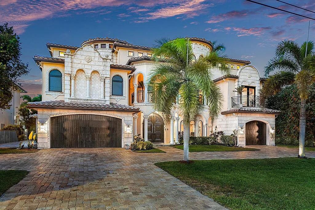 Nestled in the coveted beach block of Delray Beach Shores, a stunning residence awaits. This palatial waterfront estate captures hearts with its breathtaking custom finishings, custom interior and awe-inspiring views. With a rare 3 full floors totaling 9,674 sqft, 6-7 bedrooms, 7.2 baths, elevator, state-of-the-art theater, +more, this residence is the epitome of luxury living. Discover a gourmet kitchen, castle stone flooring, and an inviting heated infinity pool. Ideally located just 1 block from the ocean and chic Atlantic Ave, this home offers the perfect blend of tranquility and convenience. For those seeking an elevated lifestyle, nearby private clubs add an extra touch of exclusivity. Immerse yourself in the dream of luxury waterfront living. MOTIVATED SELLERS Present all offers Welcome to 1011 Rhodes Villa Ave, a magnificent Mediterranean Revival residence located in Delray Beaches coveted beach block of Delray Beach Shores. This stunning property is a true gem - a palatial waterfront estate with breathtaking custom finishings, offering spectacular picturesque views. 

Situated in the heart of Delray Beach, just minutes away from the ocean and the chic Atlantic Ave, this rare full three-story masterpiece boasts a total of 9,674 square feet of pure luxury. With 6-7 bedrooms, each with its own ensuite bathroom, this estate ensures comfort and privacy for all. There are 7.2 baths, an elevator providing easy access to all floors, a state-of-the-art theater for entertainment, and a spacious 3-car garage.

Inside the residence, a cozy library and a fitness center await, while gorgeous panoramic sunset / sunrise views of the Intracoastal waterway can be enjoyed from the Primary Suite and various vantage points. On the first floor, a bedroom with a loft is currently being used as an office or library, offering a tranquil space to work or relax.

The interior of this exquisite estate is filled with custom upgrades that showcase impeccable taste and craftsmanship. The gourmet kitchen, designed for the most distinguished chef, features top-of-the-line appliances, including a subzero refrigerator. Custom cabinetry and a unique granite countertop island add elegance to the space, while a barrel domed Chicago brick ceiling creates a cozy atmosphere. The residence boasts volume ceilings, castle stone flooring, and custom hand-carved imported solid mahogany doors, exuding luxury and sophistication at every turn.

Outside, a heated infinity pool awaits, offering a refreshing dip on warm days, accompanied by a relaxing jacuzzi. The pool area is surrounded by the breathtaking scenery of the Intracoastal, allowing homeowners and guests to unwind while taking in the beauty of their surroundings.

This magnificent Intracoastal Estate is perfectly located "beach block" from iconic Atlantic Dunes Beach. Downtown Delray Beach is also just a stone's throw away, offering an array of chic restaurants and retail shops to explore. This vibrant neighborhood makes Delray Beach the perfect place to live, work, and play.

For those seeking exclusive private club experiences, within a five-minute drive, you can find yourself surrounded by three prestigious Palm Beach County clubs: the Boca Raton Resort, Country Club, and Beach Club. These clubs provide additional opportunities for recreation, socializing, and indulging in a luxurious lifestyle.

This Mediterranean Revival residence in Delray Beach is truly a dream come true for those seeking a luxurious waterfront lifestyle with unparalleled beauty and convenience. Its unique features, stunning views, and impeccable design make it a place where dreams become a reality. For those interested, private owner lending is an option.