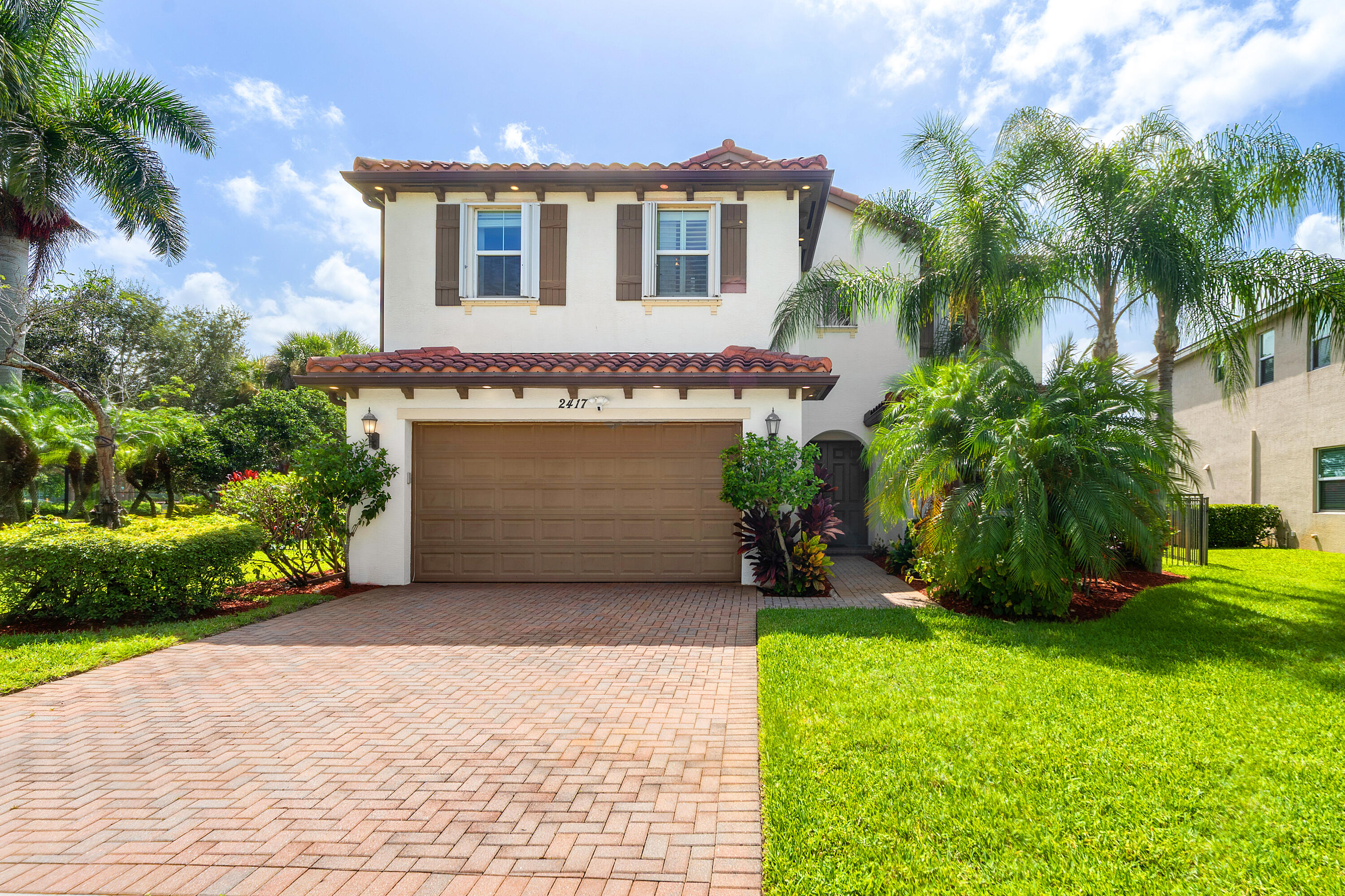 Welcome to this spacious and beautifully maintained 5-bedroom, 4.5-bath residence offering 2,834 square feet of thoughtfully designed living space in the highly sought-after gated community of Portosol. Built in 2013, this two-story home features a bright, open floor plan that seamlessly connects the main living areas, creating the perfect space for both everyday living and entertaining. A separate formal dining room provides an elegant setting for family gatherings and special occasions. The desirable layout includes a full bedroom and bathroom on the first floor, ideal for guests or multigenerational living. Upstairs, a generous loft with a closet offers the flexibility to easily convert into a sixth bedroom, home office, or media room. Situated on a premium corner lot, the           fully fenced backyard backs to a peaceful preserve, providing added privacy and tranquil views. A two-car garage completes this exceptional home. Residents of Portosol enjoy resort-style amenities, including a clubhouse, fitness center, resort-style pool, tennis and basketball courts, playgrounds, and scenic walking paths. Conveniently located just minutes from downtown West Palm Beach, Palm Beach International Airport, major highways, shopping, dining, and everyday conveniences, this home offers the perfect combination of space, comfort, privacy, and convenience.