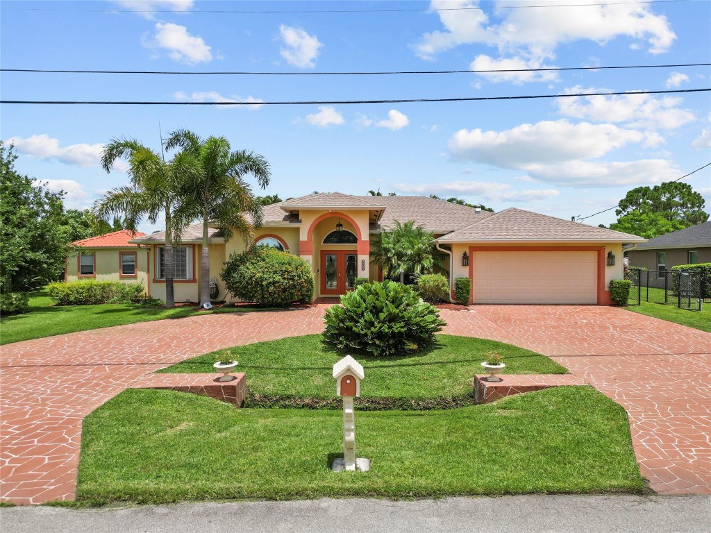 Gorgeous 5 bedroom/3 full bathroom Pool & Spa home on a corner lot in the Torino neighborhood of Port St. Lucie.  This lovely home has beautiful Spanish tile flooring with plenty of living space and features a spacious kitchen with a center island, stainless steel appliances, granite counters, and a large pantry.  The master bedroom has pretty bamboo wood flooring, a tray ceiling, triple French doors overlooking the pool, double walk-in closets.   The ensuite master bathroom is beautiful w/ pretty cabinetry, dual sinks, walk-in shower and Japanese-style jetted soaking tub.  The pool and spa are solar heated for year-round use.  This home also features a whole house GENERAC Generator, whole house surge protector, impact resistant/energy efficient windows & doors. NEW ROOF 2023!  NO HOA!
