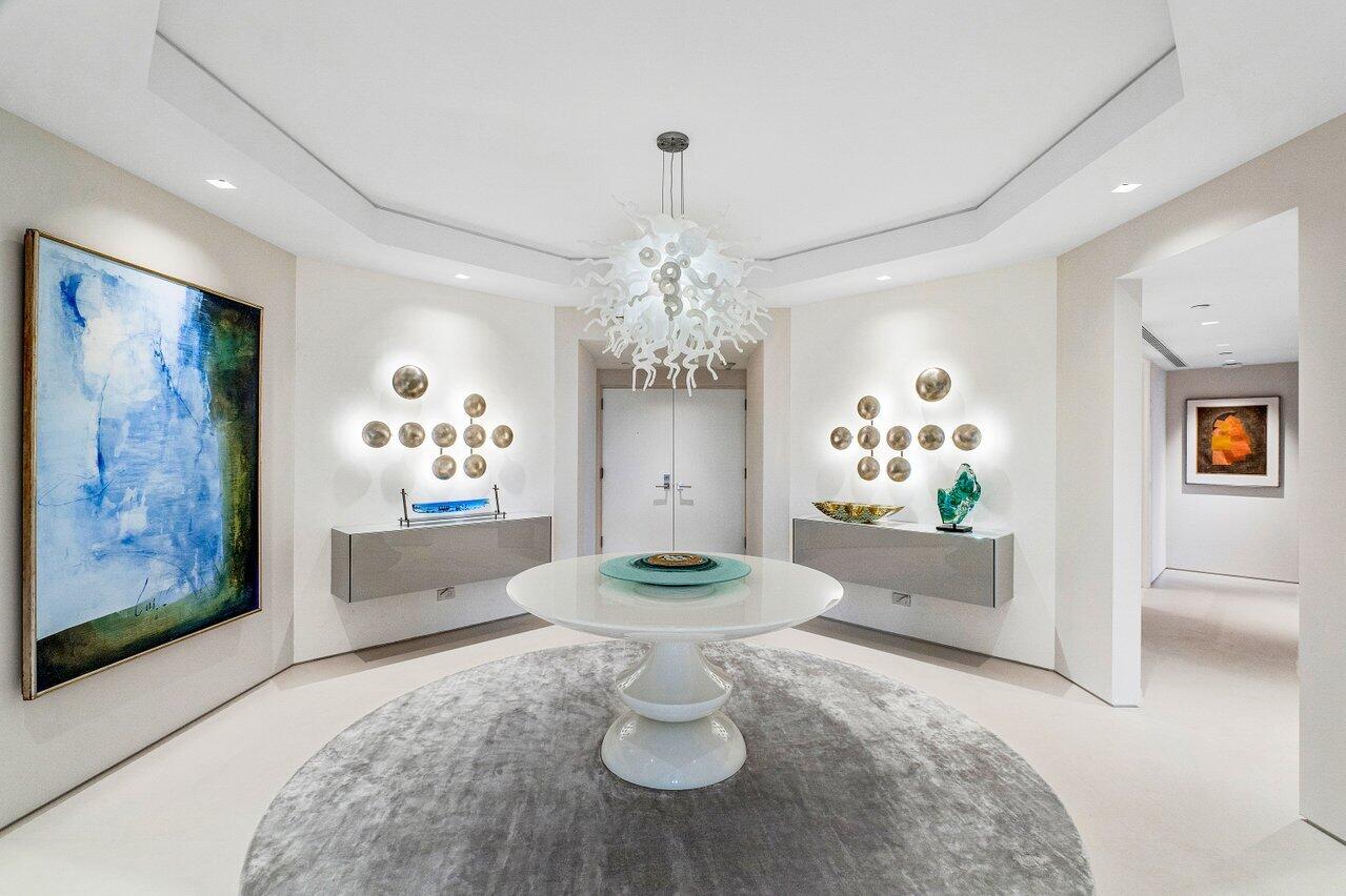 A luxuriously spectacular apartment in an exceptional building. 2000 Sloan's Curve is known to be one of the premier Associations in Palm Beach, and this is one of its finest apartments. With three distinct views enjoyed by its wrap-around terrace, including the Intracoastal, gardens, and ocean, it provides amenities- rich condominium living of the highest order. A short drive to the town center, Worth Avenue, and the Palm Beach Day school, this package includes beach, pool, six tennis courts, a fully staffed clubhouse, and a fitness center.
Light fixtures do not convey unless ourchased furnished. The condo includes a long list of the finest features, including double sheetrock "floating walls," large profile limestone floors, an intercom system, white jade countertops, Lutron lighting and temperature control system, electric blinds and blackout shades, fully tiled bathrooms with custom floating cabinets, a complete compliment of high-end Wolf and Sub-Zero appliances, a WiFi enabled leak detection and water shut-off system, and custom built-ins and cabinets.



A full staff of security personnel, maintenance, and service personnel, two assigned parking spaces, two storage units, two gyms, two spas, a yoga room, and a party room with kitchen complement the luxurious and peaceful ambiance of this apartment. The condo is in perfect mint, move-in condition, and should be visited asap because it will not last long.