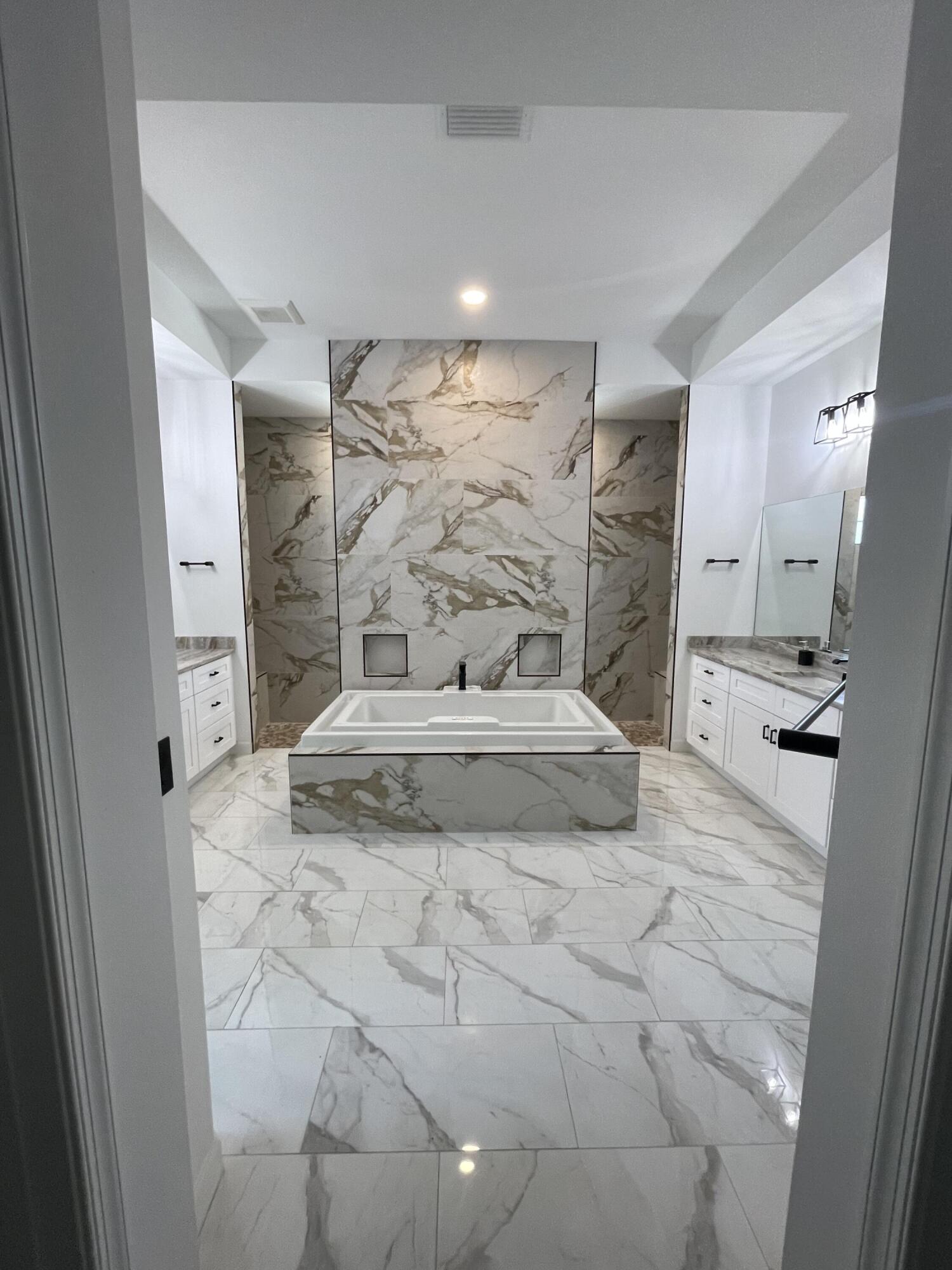 Located in one of the most sought-after communities in the Port Saint Lucie area, this 2022-built home provides a combination of privacy, space, and convenience that is hard to find.  Situated on a 1.89-acre lot within a gated community with 24-hour security, the property provides plenty of room to enjoy while still being close to everything. One of the unique advantages of this homesite is its ability to accommodate a future detached structure, whether you're considering a guest house, pool house, workshop, RV garage, or boat storage.  The neighborhood is known for its quiet atmosphere, larger homesites, and access to three PGA golf courses. While it boasts a private setting, you're only minutes from shopping, restaurants, schools, medical facilities, and everyday conv eniences. Easy access to I-95 makes commuting and travel simple.  Inside, the home features modern finishes and an open, well-maintained layout. Built in 2022, it includes impact-rated windows and doors throughout, electronic window shades, and updated appliances and systems that reflect the home's newer construction. The heated and air-conditioned three-car garage provides additional flexibility for storage, hobbies, a home gym, or workshop space.  Another benefit of owning a newer home is the potential for lower insurance costs, thanks to current building standards and impact-rated construction.  Whether you're looking for room to spread out, a property with future expansion possibilities, or simply a newer home in a desirable location, this property allows for a great opportunity to enjoy both privacy and convenience in one of Port Saint Lucie's premier communities.