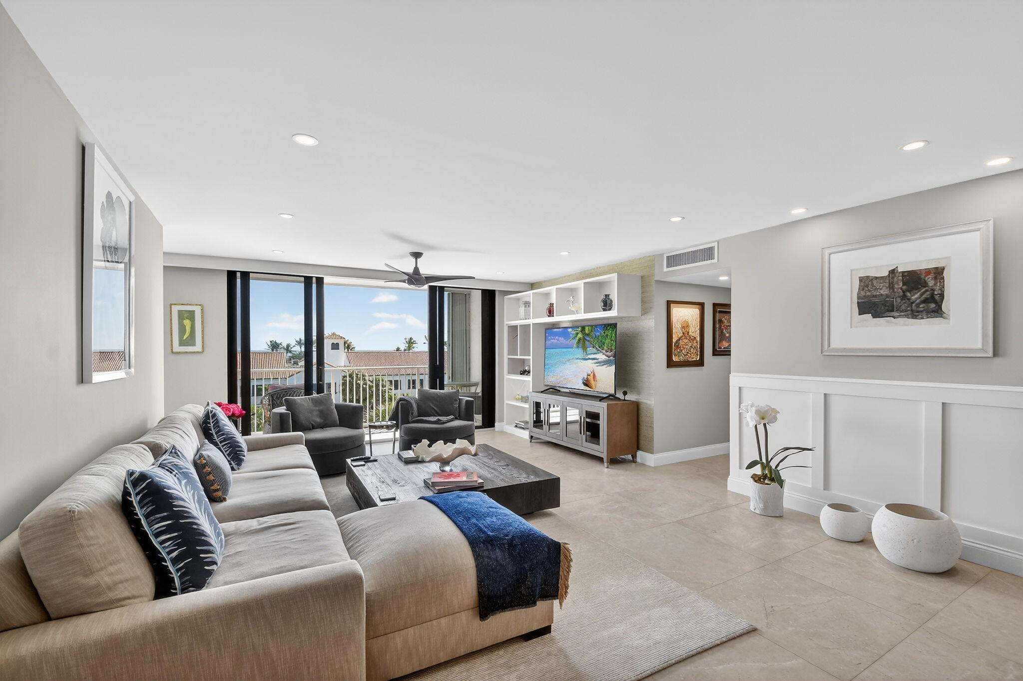TURNKEY BRIGHT SUNNY CORNER RESIDENCE WITH OCEAN AND INTERCOASTAL VIEWS & Deeded Beach Access. Beautifully renovated and impeccably maintained, this sun-filled corner unit offers sweeping water views from every room, overlooking the ocean or the intracoastal. Impact windows, custom wainscoting, crown molding, 7'' baseboards, and 24'' porcelain tile flooring create a cohesive and refined interior. The updated kitchen and baths remain stylish and functional, complemented by abundant natural light throughout. A combo washer/dryer is included for added convenience. Deeded ocean access is located just across the street. Ideally situated near restaurants, shops, and the Farmer's Market, this residence offers exceptional walkability and effortless coastal living. Covered parking #93, uncovered #9