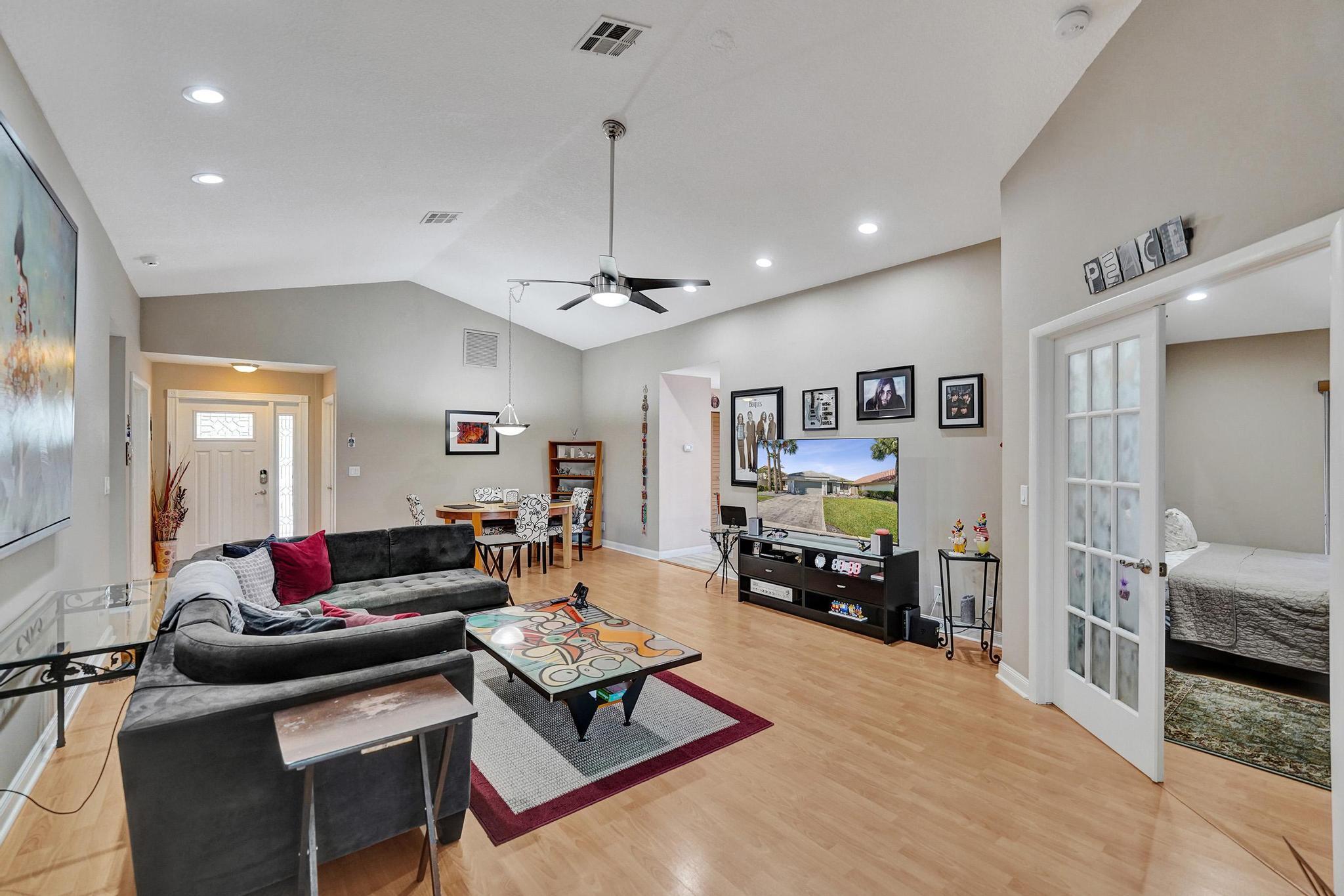 100% move-in ready in sought-after Cross Creek! Beautifully updated 3-bed, 2-bath waterfront home shines with vaulted ceilings, bright open living, true South Florida lifestyle. The kitchen features wood cabinets, granite counters, and stainless steel appliances. Updated baths include new vanities, new shower enclosure, spa-style primary cabana bath with jacuzzi tub. Plantation shutters. Enclosed patio creates the perfect Florida room/flexible living space. Low maintenance pavers at front entrance, driveway, and in fully fenced backyard ideal for relaxing or entertaining. Newer A/C, new water heater, LED lighting, modern flooring. Generator ready, full hurricane protection. 2-car garage. HOA covers lawn care, trees, sprinklers, lake, and path. Close to shopping, dining, highways!