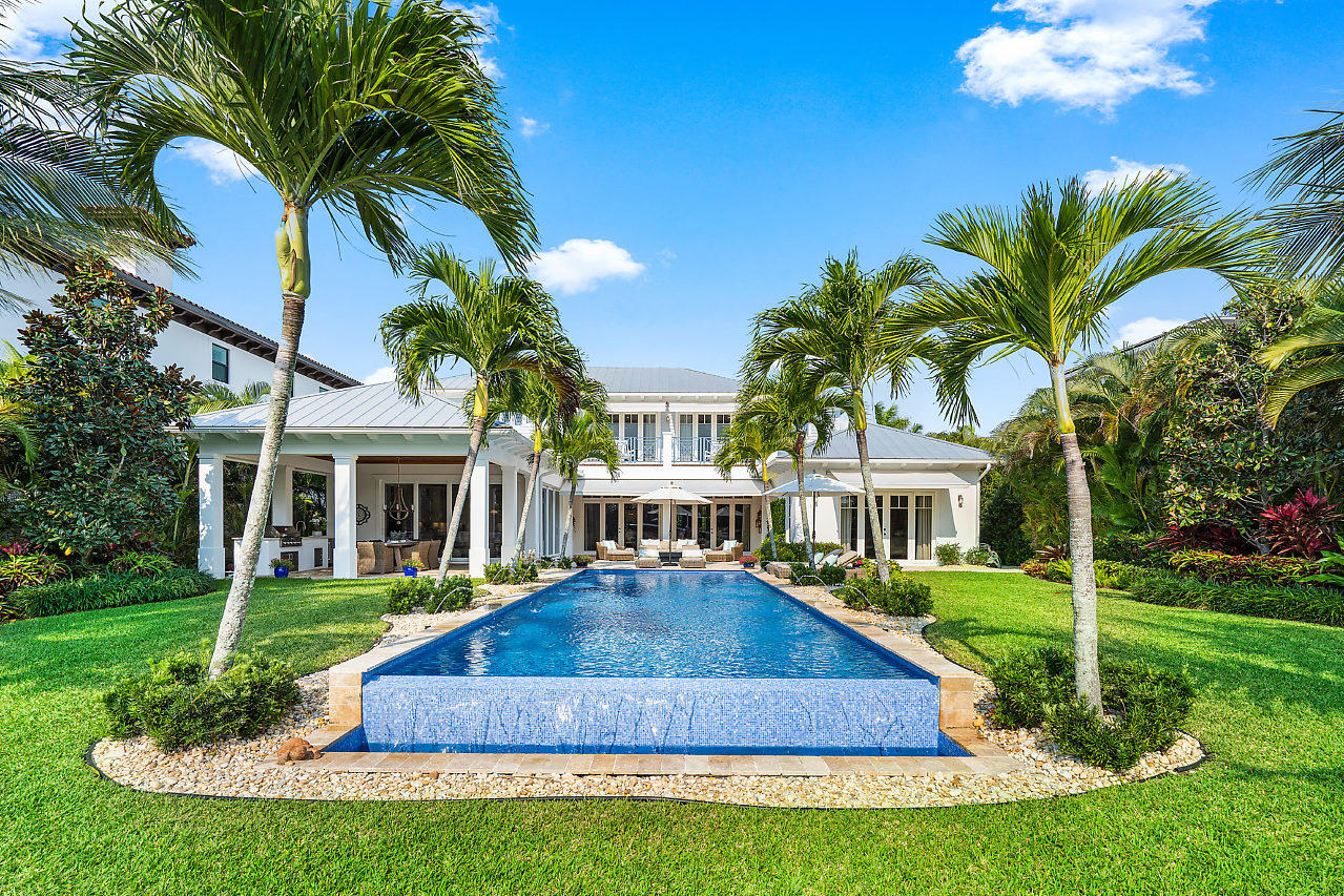 1745 Palm Trail, Delray Beach – A refreshing 2016 gated estate boasting Modern Coastal Elegance with unobstructed direct intracoastal waterway views and The Gulfstream Golf Course. A true trophy property, this intracoastal estate stretches 83' of waterfront and is over 200' deep creating a tropical paradise worth reveling in. Located along one of Delray Beaches most coveted streets, this Palm Trail location offers the ultimate in location and privacy. A well thought out floor plan with highlights including the master bedroom and 1 guest suite down stairs, 3 car garage, open floor plan blending living and entertaining spaces in perfect balance, walls of glass overlooking the pool and expansive private back yard. Interior luxury finishes include warm natural wide oak floors, quartz...... counter-tops with waterfall accents, custom wall details, wood accented ceilings, custom lighting and sound system and fireplace. Outside are giant covered lanais, a full covered outdoor kitchen and tropical setting all combine to make this a truly magnificent private paradise. On the 2nd floor, 3 additional bedroom suites and a large loft open to a balcony with incredible views of the intracoastal and Gulfstream Golf Course. The entire home and seawall are newly built in 2016 with the finest in construction quality and luxurious finishes. Additional features include all impact windows and doors, propane gas appliances, metal roof, 3 car garage, gated, 17K pound remote controlled boat lift with high speed motors, mud room and a backup power generator. This magnificent home is being offered furnished with exclusions. Please call for details.