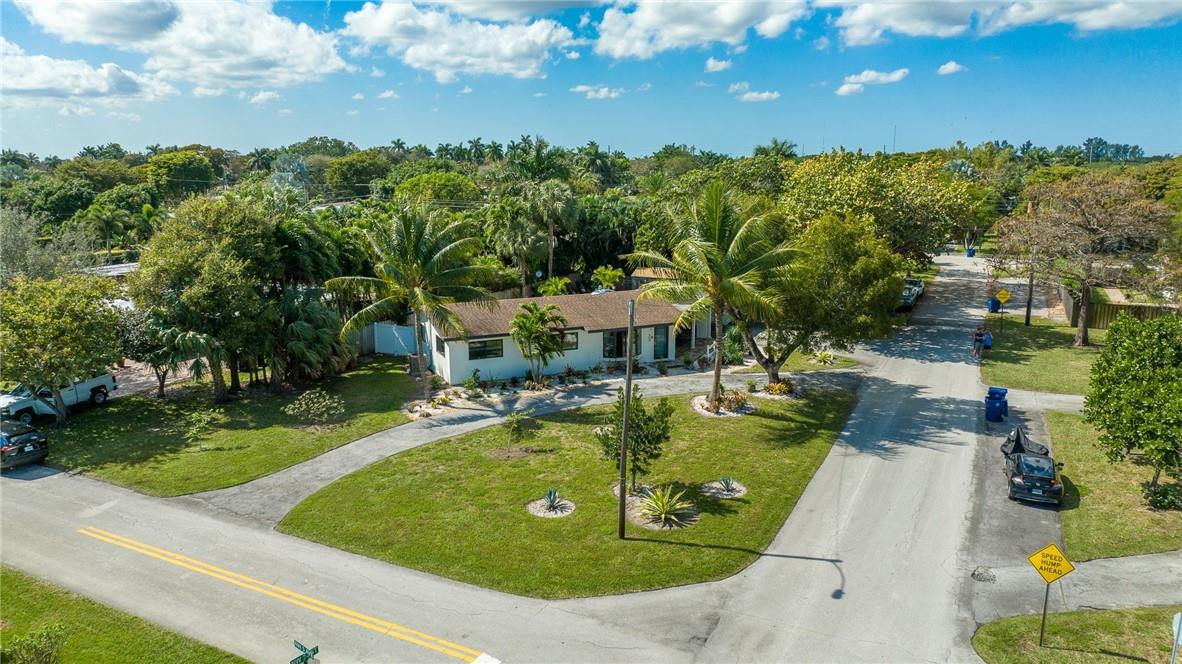 WOW! RARE opportunity for an oversized 11,481 sq ft corner lot in Wilton Manors. Remodeled in 2013, including a new roof, this 3 bedroom, 2 bath home has plenty of space to expand. New impact windows & doors greet you as you enter this tranquil abode. The bright and airy space is sure to delight! The newly xeriscaped back yard is perfect for outdoor living and comes with a "flex shed" perfect for a gym, office, or extra storage. The relaxing covered front porch with double fan is perfect for enjoying paradise. The carport fits 2 large vehicles & has built in storage closets.  Lots of guest parking with regular & circular driveway. Act fast as a lot this size will move quickly. Investors: a neighboring home just sold for $1.445m! (All info believed accurate but not warranted)