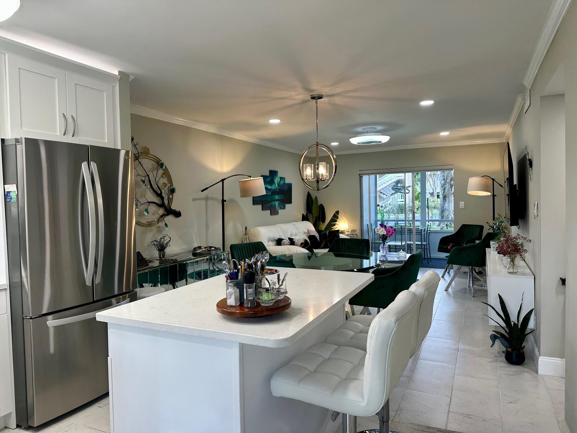 This beautifully renovated condo is truly move-in ready, fully furnished. No detail was overlooked: brand-new floors, updated bathrooms, a stunning modern kitchen with granite countertops, stainless steel appliances, and a stylish snack counter perfect for casual meals or entertaining. Enjoy the outdoors on the large covered screened-in patio with peaceful garden views and refreshing southeast breezes. 6/12 MONTHS RENT AVAILABLE!!! Located in the vibrant 55+ community of Lake Clark Gardens, this condo offers more than just a home—it's a lifestyle. Residents enjoy outstanding amenities including a clubhouse, fitness center, and pool, creating the perfect environment for relaxation, activity, and connection.