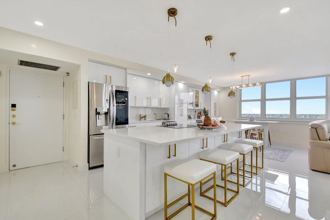 UNFURNISHED ANNUAL or Can Purchase the Unit!!! **To experience the Lifestyle Tour and feel the space beyond photos, view Video 1 under Photos for an immersive preview.** Imagine waking up every day and the first thing you see is the ocean staring right back at you. That's what this place is like. It's not ''close to the beach,'' it's literally on the beach. You walk out of the building and boom, you're in the sand. It feels like you're living inside a postcard. The condo is on the 10th floor, and everything inside is brand new. I mean everything. Floors, kitchen, bathrooms... all of it redone with that clean white, glossy, everything-soft-close, beautiful-lighting kind of perfection. It feels like someone took an HGTV dream home and said, ''Let's make it even better.'' (SEE SUPPLEMENT)... The whole space is open, so no matter what you're doing, the ocean is right there in front of you. Then you walk into the living room and these giant wraparound windows hit you with views from every angle. And the balcony? I can't. It's glass, modern, long, and the kind that makes you want to sit outside all day. On one side you get the ocean, on the other you get the intracoastal. Sunrise coffee, sunset wine, all from the same spot. The bathrooms feel like a fancy spa. The mirrors light up, the rain shower falls from the ceiling, and everything just feels soft, clean, fresh and expensive in the best way.
And the pool is up on a raised deck right over the ocean. You're lounging, swimming, grilling, all with the waves in front of you like your own private backdrop. Then you walk right out to the sand to collect shells, take a walk, or just sit under an umbrella and do absolutely nothing. You're also close to everything you'd ever need. Airport, shopping, restaurants, and the Brightline train is so convenient if you want to shoot down to Boca for some shopping, Ft Lauderdale to see a show, or Miami for dinner. The building already did all the important reports, so you don't have to worry about any surprises. You can just move in and enjoy your life. It's perfect for a second home, a beach escape, or going all in on the oceanfront lifestyle full-time. You're going to fall in love the moment you see it. It's that good.