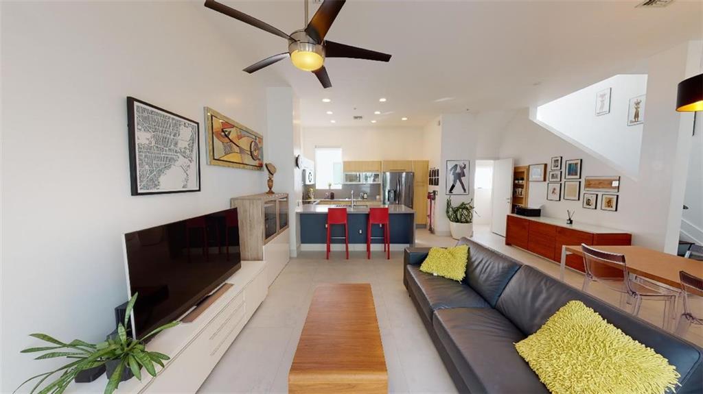 Meet this “meticulously designed” Bamboo Flats Townhome in the Heart of Flagler Village. This rarely available townhome features an oversized rooftop terrace and is ready for your new hot tub and or outdoor kitchen. Enjoy some amazing views of downtown while you sip your favorite wine or champagne. Custom 1 x 1 meter Italian porcelain floors in the main living area and espresso wood floors throughout the rest of the home.    A very open and lofty feel with an abundance of natural light. 9, 10 & 11-foot ceilings, custom shades, & built-in closets throughout. The open concept kitchen with a quartz waterfall countertop is perfect for entertaining. The 2 car garage with plenty of storage space for your cars and your tools. Come see this unit, it will not last!