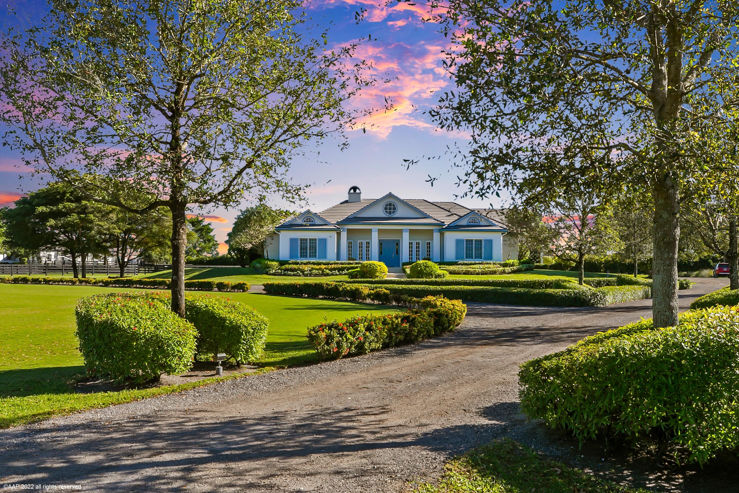 Income producing & for all disciplines! Beautifully appointed home, private 28 stall barn, grass Grand Prix field, covered arena, outdoor ring, euro-walker & round pen on 8.85 acres. All perfectly situated on a beautifully manicured 8.85 acres & just minutes to the WEF, Global & IPC competition venues. The stable boasts 2 mirror image wings: 8 wash stalls, 2 tack rooms, 2 feed rooms, 2 laundry rooms, 2 kitchens, 2 bathrooms, & 2 storage rooms. The 4 bedroom residence with office has an open concept great-room with center-island kitchen, professional gas range,  quartz counters, stunning glass enclosed wine cellar & beautiful wood floors throughout. The primary bedroom suite has a spa-like bath which opens out to a romantic outdoor garden shower.  See ''Supplement'' for additional features. The covered arena has the underground ebb & flow watering system, viewing platform with center-island bar, plus workout room and additional garage storage at the west end. (Gym equipment excluded).

There are 3 gated entrances to the property and a circular driveway at the barn, providing easy access and parking for trucks, trailers and vans.

OTHER FEATURES:
Wood burning fireplace
Spa tub in primary bedroom suite
Gas heated, salt pool
Summer kitchen
Central vacuum

230' x 90' Outdoor arena - expandable
Large turf Grand Prix jumping field
60' round pen
6 Horse walker
5 grass turnout paddocks
Irrigation from well
Generator hookups at house & stable
RO water treatment system for house & stable
AT&T Internet
DirectTV