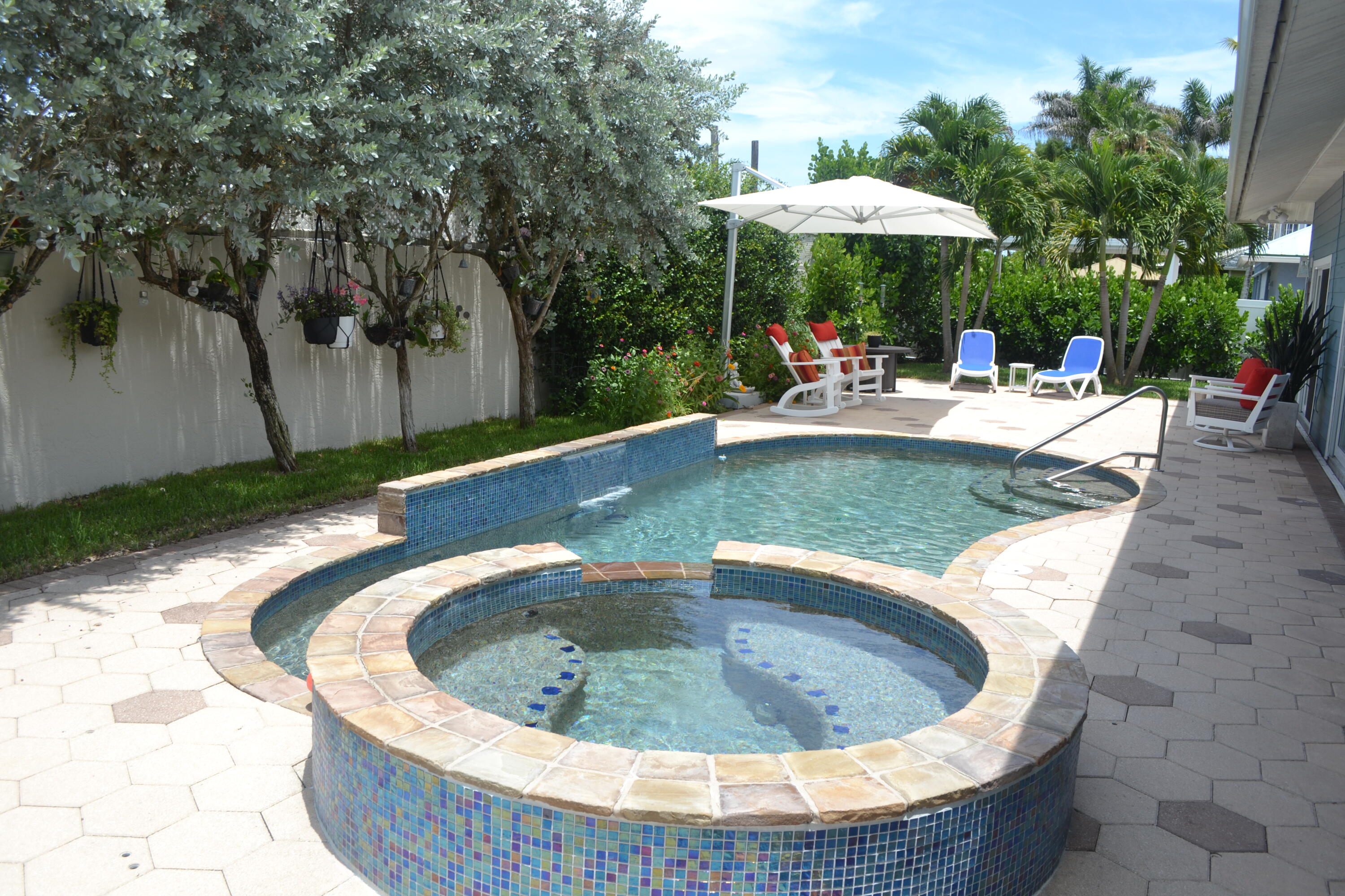Experience the charm of a Key West-inspired retreat in the heart of Jupiter. Nestled in a sought-after coastal neighborhood with a private boat ramp offering ocean access, it's the perfect place to launch smaller boats, kayaks, and paddleboards. Inside, nearly every detail has been thoughtfully renovated and updated, creating a fresh, move-in-ready home. Hurricane-ready impact windows and doors provide peace of mind, while the standing seam metal roof was replaced in 2021. The impressive list of upgrades includes custom lighting, a wine cooler, water softening system, a solar-heated pool, custom closet storage, wood-look plank tile flooring throughout, and so much more. Interior photos will be available next week—stay tuned!