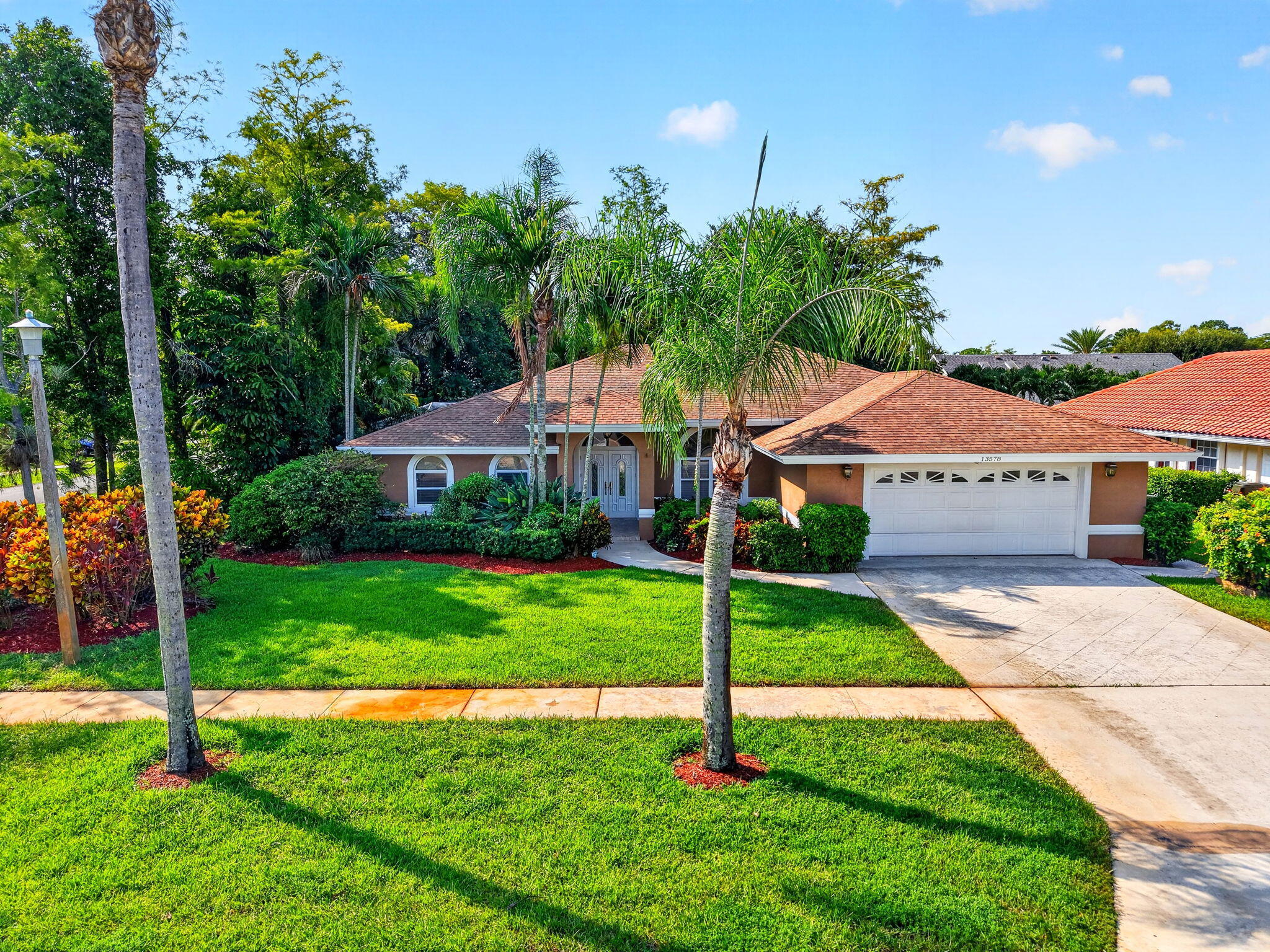 Move right into this beautifully updated 4-bedroom, 3-bath split-plan home in a highly desirable neighborhood with NO HOA! Light & bright throughout, this spacious residence features luxury vinyl plank flooring, cathedral ceiling & skylight that fill the home with natural light. Enjoy a formal dining room, separate breakfast nook & updated kitchen with newer appliances that opens to the family room. The generously sized bedrooms offer abundant closet space, while the primary suite includes an updated bath. Step outside to the covered & screened patio overlooking the pool on a beautifully landscaped corner lot with a cabana bath & plenty of room for entertaining. Panel storm shutters. Conveniently located near A-rated schools, shopping, dining, equestrian venues & Wellington events. Roof 21 years old (40 year shingles), appliances approximately 5 years old, hot water heater 2015, the living room could be closed in to be used as an extra bedroom or office/den