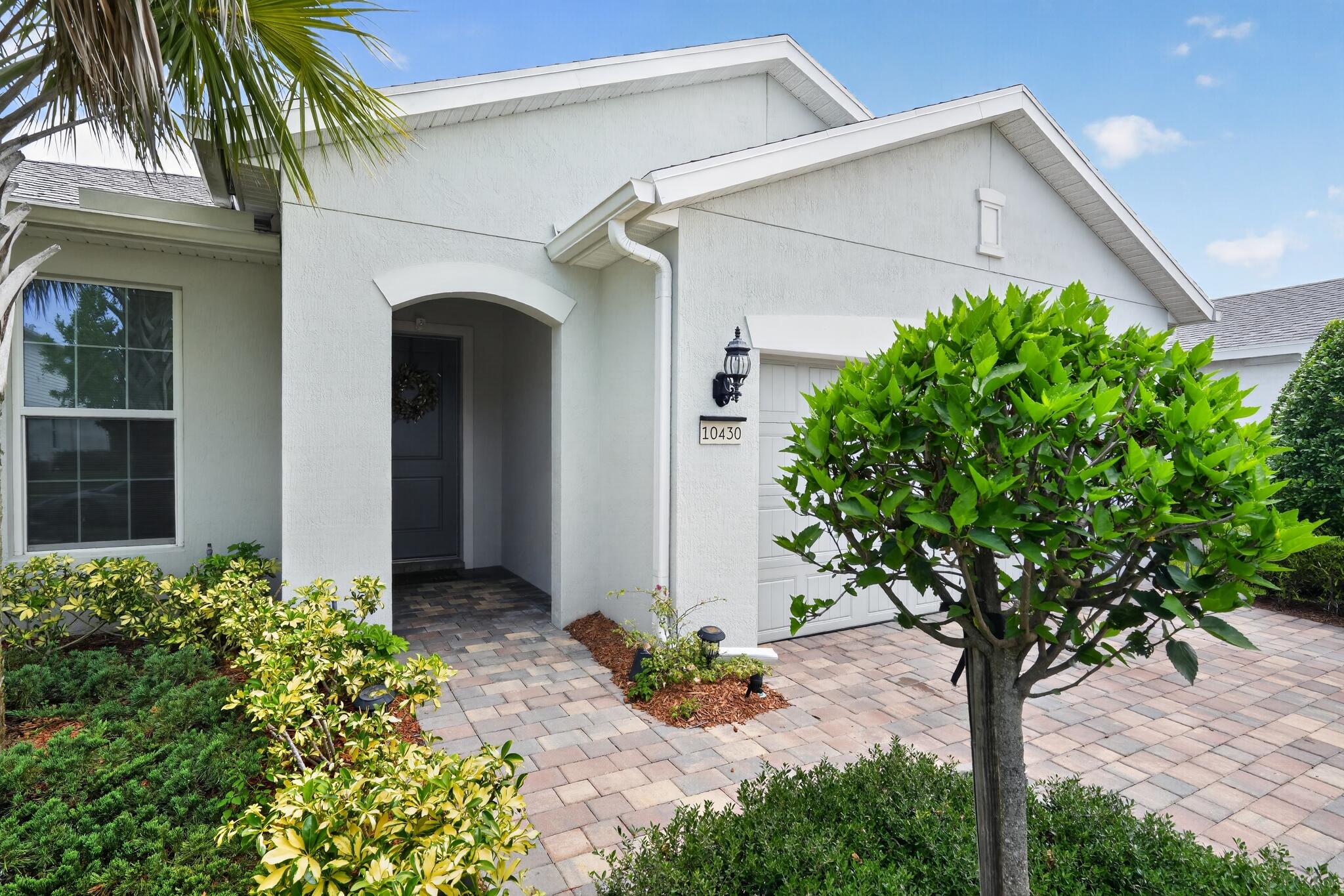 This stunning 4-bed, 3 full bath home checks all the boxes in the highly desirable Heron Preserve community within the master-planned Tradition in Port St. Lucie. Securely gated, this home offers an inviting open floor plan with neutral tones and a desirable split-bedroom layout. Featuring premium upgrades throughout, including gas appliances, impact windows, tray ceilings, crown molding, and elegantly selected finishes. Enjoy spa-like primary baths with walk-in showers and dual sinks. Resort-style community amenities include a sparkling pool, kids' play area, and breathtaking dual views of lush gardens and partial water. Backing to the southwest, the home captures gorgeous Port St. Lucie sunsets, ideal for relaxing evenings on the screened in lanai.    Tradition is a vibrant, master-planned community in Port St. Lucie offering resort-style living with over 500 acres of sparkling lakes, 300+ acres of parks and preserves, walkable trails, a charming Town Center with shops, dining, and events, plus top-tier amenities like community pools, playgrounds, fitness centers, and more, making it one of the most desirable places to call home on the Treasure Coast.