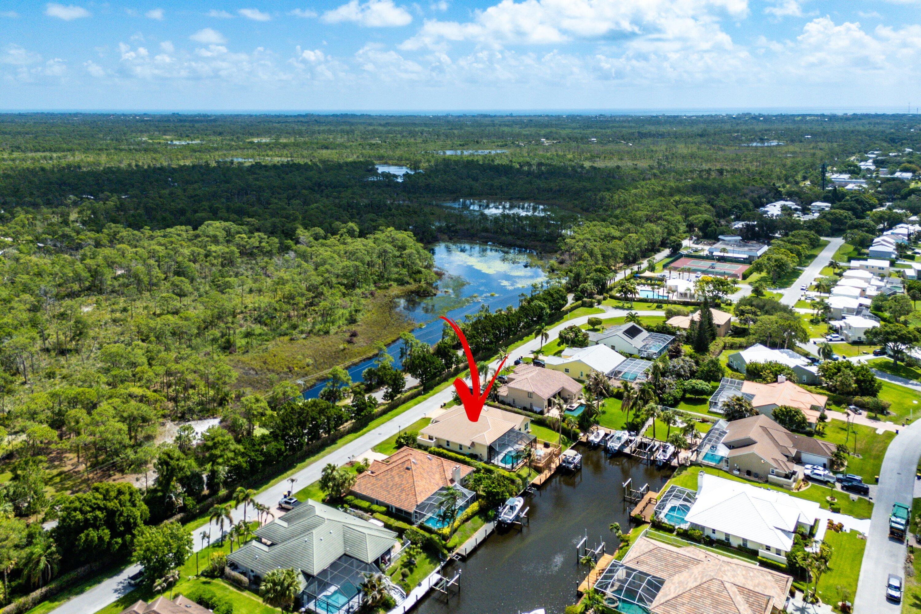 Beautiful waterfront home located in the gated golf & boating community of North Passage. Set along a deep water canal, this property captures the relaxed luxury of South Florida living.  This 3b/2.5b home offers over 2,600 sqft of living space with soaring ceilings, abundant natural light, impact windows, and peaceful water views throughout the main living areas. The split floor plan & spacious layout is perfect for both everyday living and entertaining.  Step outside to your private backyard oasis featuring an oversized deck, sparkling heated salt water pool, lush tropical landscaping, private dock, boat and jet ski lifts. This home is designed to enjoy the very best of waterfront living.  North Passage offers gated security, golf course surroundings, tennis, & clubhouse amenities.