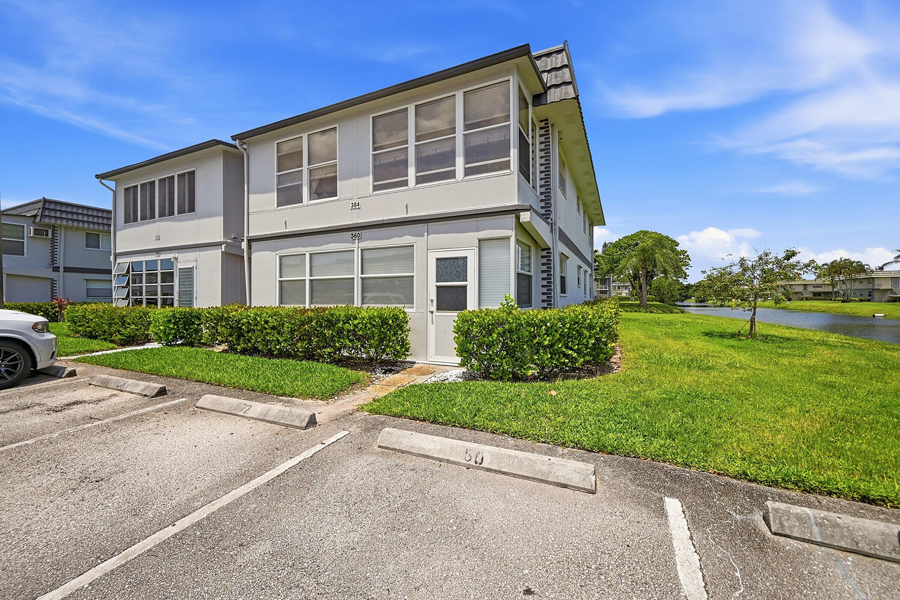 This bright 2nd floor home offers peaceful water views, an open living and dining area, tile flooring throughout, and an enclosed patio.  Primary bedroom features ample closet space while the kitchen offers white cabinetry, granite countertops, and plenty of storage. Kings Point residents enjoy resort-style amenities including multiple pools, golf courses, tennis, pickleball, fitness centers, a clubhouse, theater, cafés, social clubs, courtesy transportation. In unit laundry, over 55 Community.