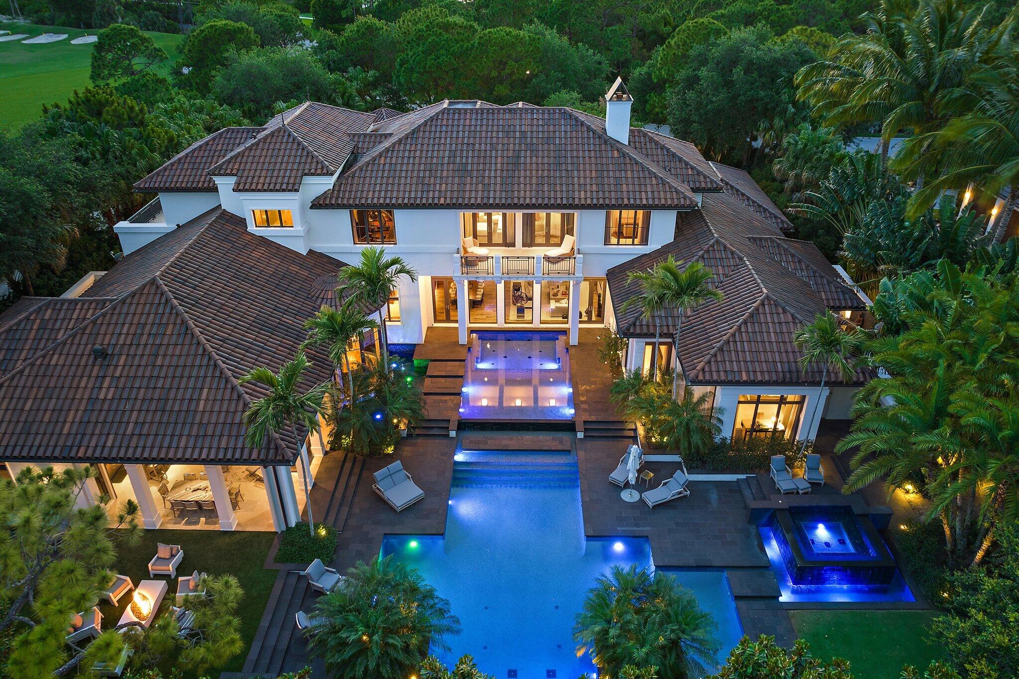 Located on nearly an acre along the second hole of the Nicklaus signature course at The Bears Club, this custom estate residence seamlessly integrates modern elements with timeless charm. This spectacular estate residence is a bespoke fusion of styles, blending the finest pieces from European and American design houses like Odegard and Lapchi , and lighting fixtures sourced from the prestigious Italian company Barovier and Toso. Intricate hand-painted wallpaper and stunning millwork adorn its interior, accentuating the architectural splendor. The Miele kitchen, designed for hosting gatherings, features high-gloss lacquer cabinets complemented by an iridescent glass tile backsplash. There have been many recent updates including the replacement and upgrades to the HVAC systems.