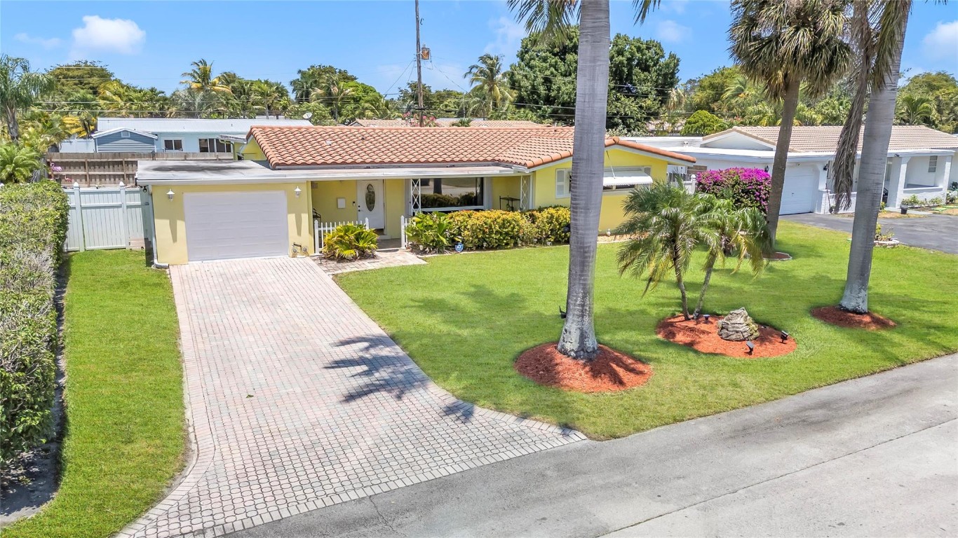 Charming ranch-style home in the highly desirable Lighthouse Point community of Hillsboro Isles. This meticulously maintained 3-bedroom, 2-bath split floor plan with a versatile studio/bonus space sits on an oversized 8,250 sq ft lot—a rare find. The open, sun-filled layout offers excellent flow for everyday living and entertaining. The property features a paver driveway, fully fenced backyard, and lush tropical landscaping with mature palms and vibrant lawn, plus room for a pool or hot tub. Ideally located minutes from the Lighthouse Point Marina, waterfront dining, shopping, parks, and beaches. A wonderful opportunity to enjoy space, privacy, and future potential in a sought-after coastal community.