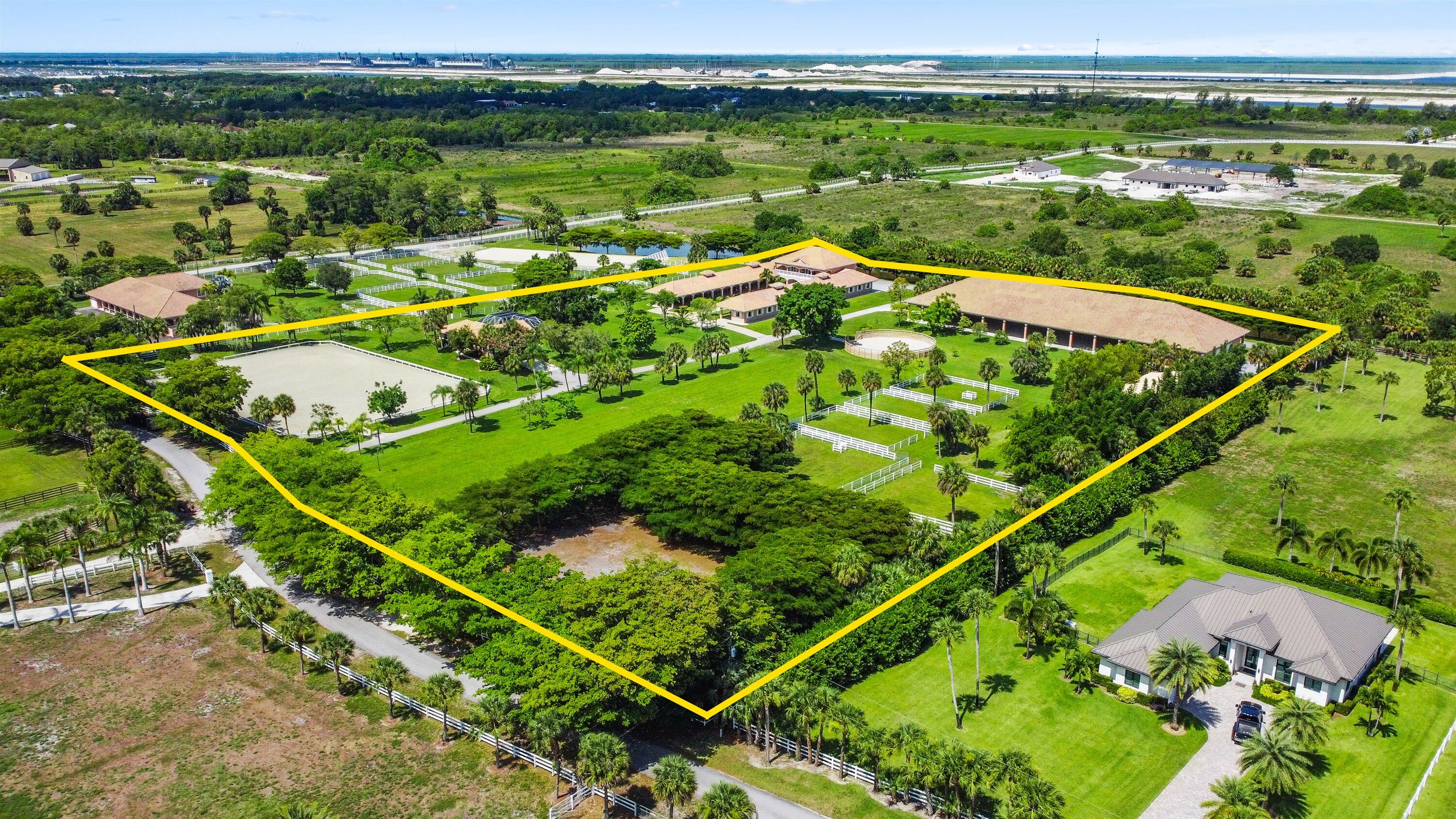 BACK ON THE MARKET THROUGH NO FAULT OF THE PROPERTY AND PRICE IMPROVEMENT! This equestrian estate is a true year-round facility spanning 10 stunning, functional acres. This farm has received many recent new improvements. (Please see Supplemental Information).The 22-stall iconic courtyard barn includes a 4-bed, 3-bathroom apartment, 4 bedroom separate pool home, 2 tack rooms, kitchen, office, feed room and 6 wash stalls - all stalls with fans, mats and fly spray. Ride rain or shine with new JTWG Premier indoor & outdoor arenas (180'x150'), new round pen and a grand prix field. New impact windows throughout. Whole-farm generator, oversized whole-farm R.O. water system, new irrigation, and paved trailer area.....