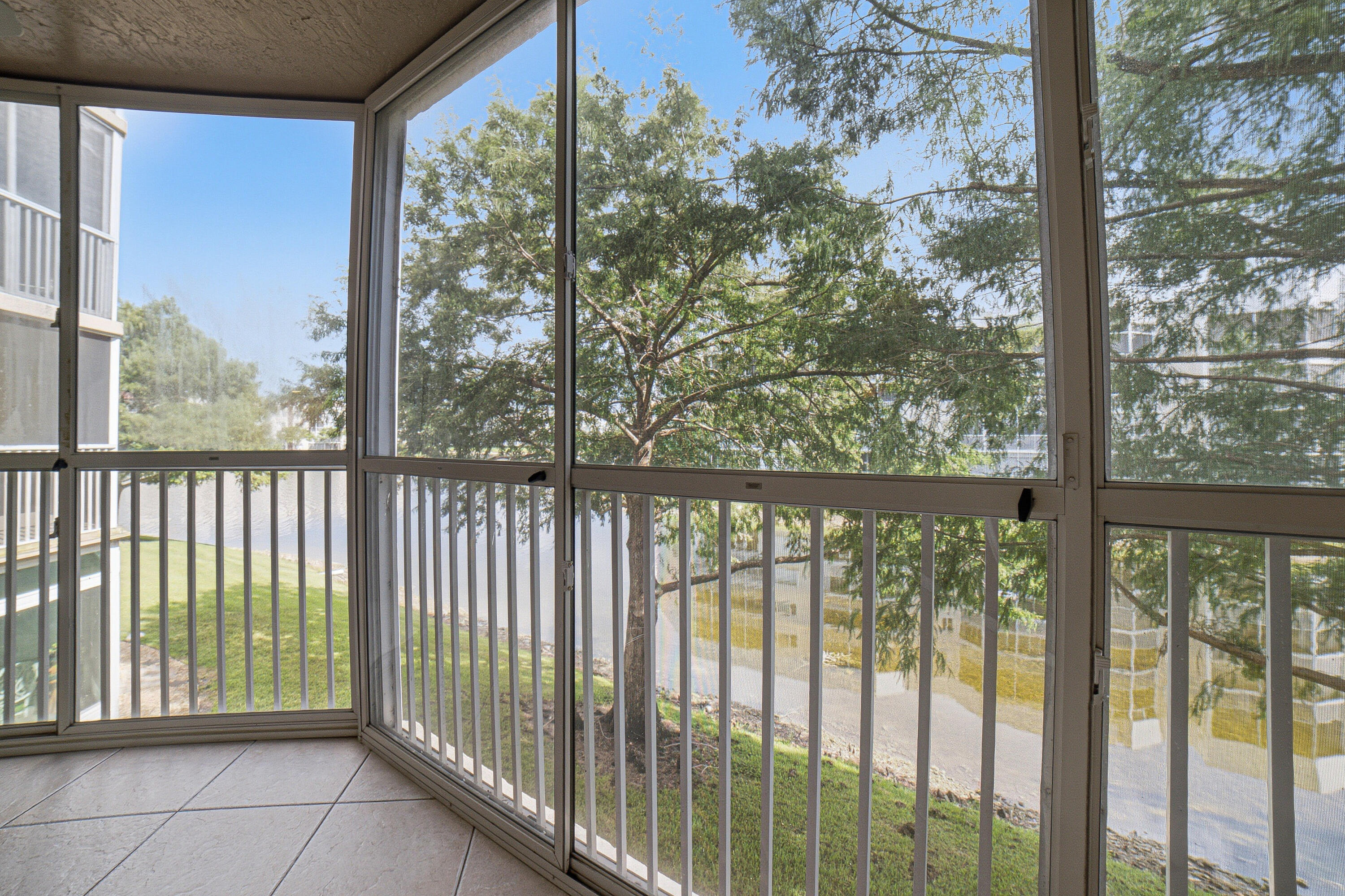 Move right into this beautifully updated 2BR/2BA condo in desirable Granville at Kings Point, Tamarac's premier 55+ gated community! Featuring a renovated kitchen and bathrooms, stylish laminate flooring, neutral colors, and a spacious screened patio overlooking a peaceful lake—perfect for your morning coffee or evening sunsets. Enjoy the convenience of an elevator building and resort-style living with a spectacular clubhouse, indoor & outdoor pools, fitness center, theater, pickleball, tennis, courtesy bus, clubs, classes, social activities and so much more. Association requires 650 Beacon score, minimum $32,000 annual income, and leasing permitted after one year of ownership. Resort living at its best!
