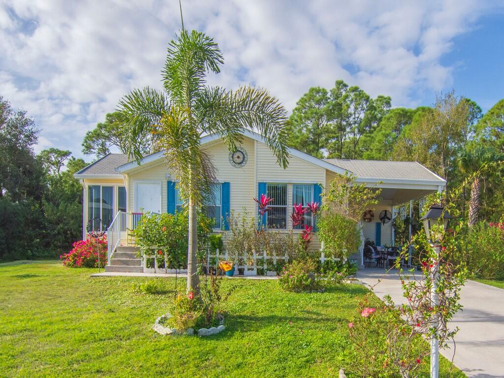 Charming Home in Heritage Plantations. Located on an inside corner lot bordering a beautiful pine and palm tree forest, a neighbor on each side whisper quiet, practically zero traffic, the home has a standard shingled roof, 1200 sq. ft, 2 BR, 2 full bathroom w/a attached mini laundry room, good condition all appliances, fully wired to a 9000 watt generator, new plywood floors with top grade slats, they offer all the amenities It is in move-in condition. They offer all the amenities, ball courts, pool, big community center. Come take a look at this beautiful home and community.