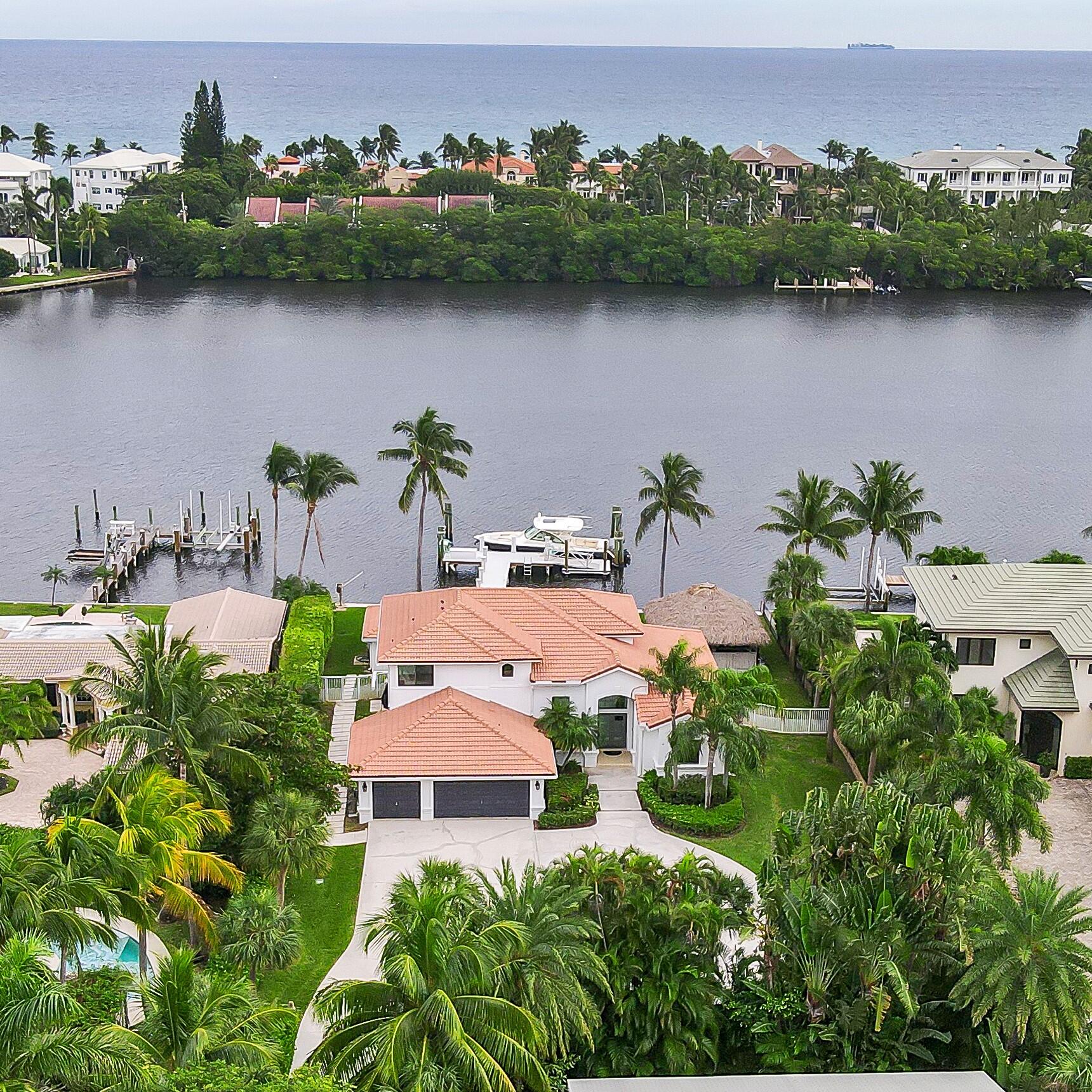 Direct waterfront gated property on Hypoluxo Island with a brand new dock, ground floor master, & 3 car garage! This beautiful contemporary home on over a 1/2 acre has 100' of water frontage, 3 bedrooms and an office/den in the main house and a full bath and small guest room in the pool house. The current owner has upgraded everything starting with brand new impact windows and doors throughout, a brand new dock with IPE decking, power pedestal, LED lighting, & fish cleaning station to Wifi controlled sprinklers, security cameras, HVAC system, & ADT security system and so much more. This is a must see!