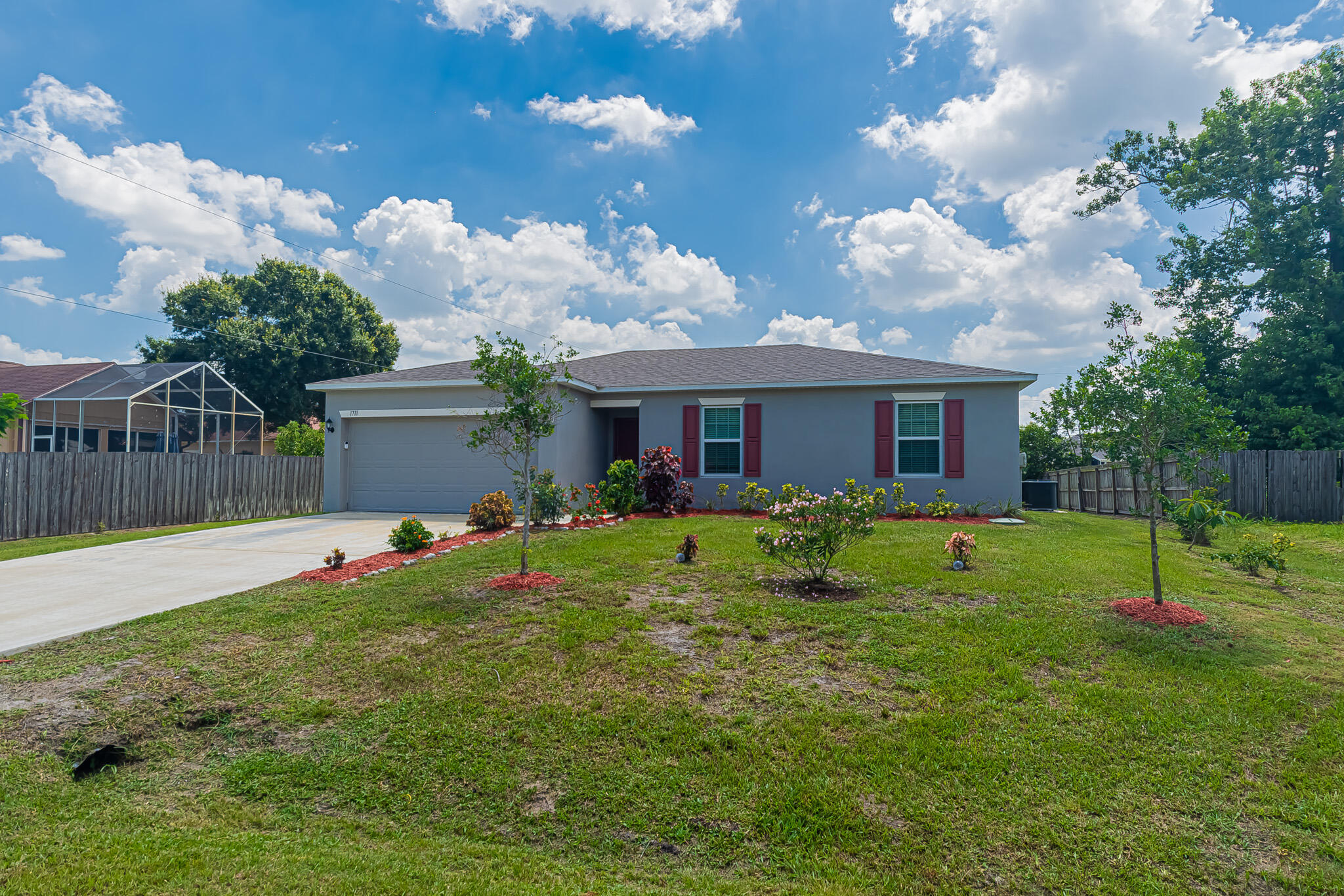 Built in 2023, this 3/2/2 CBS home perfectly combines modern design with solid storm security. The open floor plan features tile flooring throughout, vaulted ceilings,  and a split-bedroom layout  The kitchen features granite countertops, plenty of cabinetry, pantry  and stainless steel appliances. Rest easy knowing the home is equipped with complete high impact glass and full panel shutters. The property features a fully wood-fenced backyard and an open patio space perfect for outdoor living. Includes a 2-car garage and driveway parking, all with no HOA!  Check it out!