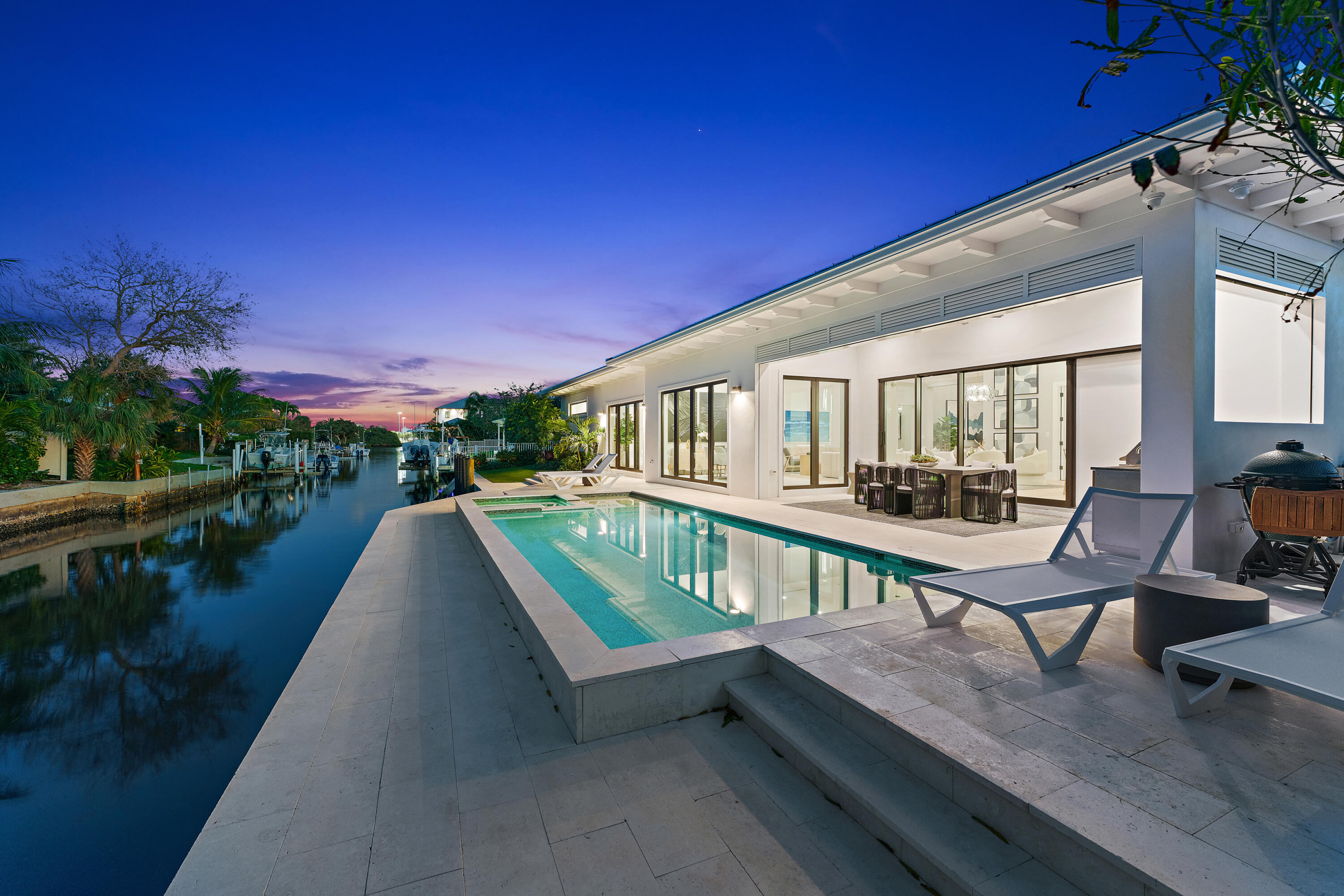 Newly constructed in 2022, the coastal contemporary waterfront lifestyle awaits in this stunning one-story, four bedroom, four-and-a-half-bathroom home featuring 100 feet of ocean-access waterfrontage with no fixed bridges, in the heart of Palm Beach Gardens! Beyond the stately foyer with 16' ceilings, natural light washes through this perfectly appointed open concept with no detail overlooked. Entertain in the great room, celebrate in the dining area, or gather in the eat-in area off the stunning chef's kitchen featuring beautiful white cabinetry finished with Quartz counters, custom stainless-steel appliances, center island with bar seating, and hidden walk-in pantry with a wine cooler and custom shelving. Retreat to the spacious primary suite with two custom walk-in closets and featuring a tranquil spa-like primary bath with dual sinks, an incredible marble shower with numerous jets and a rain shower head, and a Roman tub. Three additional spacious bedrooms feature en-suite bathrooms and walk-in closets. Relax on the covered northern-exposure patio complete with an outdoor kitchen and retractable screens overlooking the heated, saltwater pool, spa, and waterway beyond. The paver driveway leads to a full two-car garage with custom built-in storage and finished epoxy floors. Upgrades abound: a new seawall, an indoor/outdoor Sonos sound system, custom California Closets and shelving throughout, crown molding, designer light fixtures and hardware, and much more!

Enjoy all that waterfront living in the heart of Palm Beach Gardens has to offer : considerable dockage for your waterfront toys just seconds from the main intracoastal waterway, and a short cruise to the Jupiter & Palm Beach inlets, sandbars, and waterfront dining. This unincorporated Palm Beach Gardens address provides lower property taxes and is moments from incredible beaches, shopping, dining, I-95, Florida's Turnpike, and the Palm Beach International Airport!