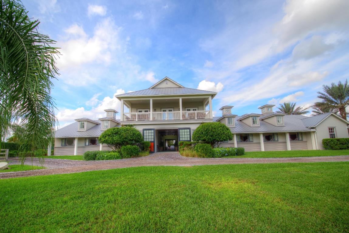 Extraordinary farm ownership opportunity in desirable Saddle Trail South. This private 6.3 acre equestrian compound is located within a very short hacking distance to the showgrounds. The stable features 17 12’x12’ Corton stalls, 3 tackrooms with kitchenettes, office, 2 half-bathrooms, 2 storage rooms, feed room, air-conditioned hay room, 7 grooming/wash stalls, vet/farrier stall with exterior access, and laundry. The second story boasts an owner’s lounge, full bathroom, workout room with rubber flooring, and balcony overlooking the grounds. Two 2-bedroom, 1 bathroom apartments complete with granite countertops, stainless steel appliances and full laundry facilities overlook the courtyard. Designed for the serious competitor, the grounds include 6 large paddocks, a covered Kraft 4-horse walker with center storage, detached utility building for tractor and jump storage, and an unparalleled 250'x190' sand riding ring with ride-on ride-off bank and 220'x200' derby field both with zoned irrigation. 

The spacious 4 bedroom plus den, 3.2 bathroom house has been extensively renovated boasting Carrera marble in the bathrooms, walk-in closets with custom cabinetry, impact windows, separate mud and laundry rooms, 2015 kitchen appliances and a "bonus room" complete with parquet flooring, built-in bookshelves and benches and a custom Mahogany wood bar with professional grade appliances. 

Additional features include whole house and barn generators, reverse osmosis water systems, security system with interior and exterior cameras, 3 separate entry gates, automatic fly spray system, and commercial ice maker in the barn. Grindstone Farm is the complete property for the serious equestrian.