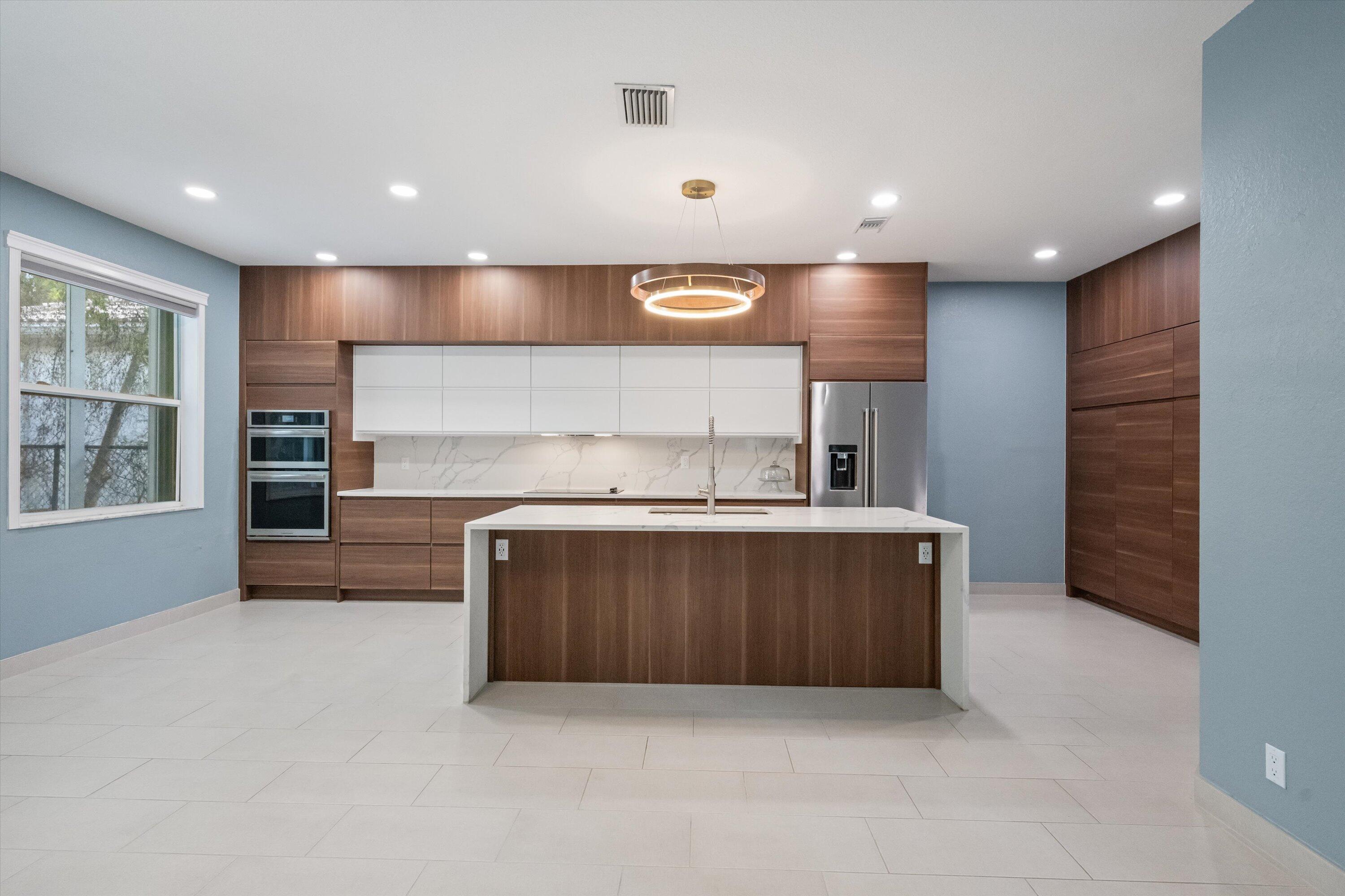 Wow! 180K in upgrades on this beautiful 4-bedroom, 3-bath home offers a modern layout and stylish finishes throughout.The home features newly renovated bathrooms with contemporary tile, frameless glass showers, and sleek fixtures.A thoughtfully designed mudroom adds everyday convenience and extra storage. The updated kitchen showcases modern cabinetry with ample storage, quality countertops, and a functional island ideal for cooking and hosting. Light-filled living spaces and tasteful upgrades make this home move-in ready. Outside, you can enjoy entertaining year-round with a Summer Kitchen perfect for outdoor dining. Located in a man-guarded community, this home is centrally situated five minutes from the beach, outlets, shopping, restaurants, and PBI. It is truly the perfect place to call home.  This house has been appraised and appraisal is available upon an executed contract.