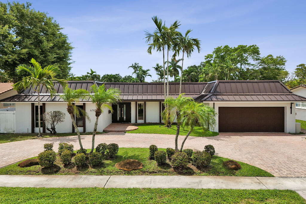 Big Ticket Upgrades. Peace of Mind for Luxury Living. Beautifully updated 4 bed, 2.5 bath home in sought-after Emerald Hills with approx. 3,000 sf of light-filled living space plus a 440 sf garage. Major 2026 improvements include a new TPO 60 roof framed by standing-seam metal, new fascia, soffits with integrated LED lighting, gutters with leaf guards, hurricane-impact windows and doors, and a resurfaced 395 sf pool and raised spa with new Diamond Brite finish and tile. Inside features marble-look tile, crown molding, designer LED lighting, open living and dining areas and a chef's kitchen with white shaker cabinetry, quartz counters, oversized island, vented cooktop hood, double ovens, paneled built-in refrigerator, breakfast nook, plantation shutters and pool views. The PVC-fenced back-yard offers a brick-paver patio, 3 fan columned lounge, 16' x 10' covered wood pergola with two ceiling fans and tropical landscaping. Move-in ready near parks, dining, major roadways and houses of worship.