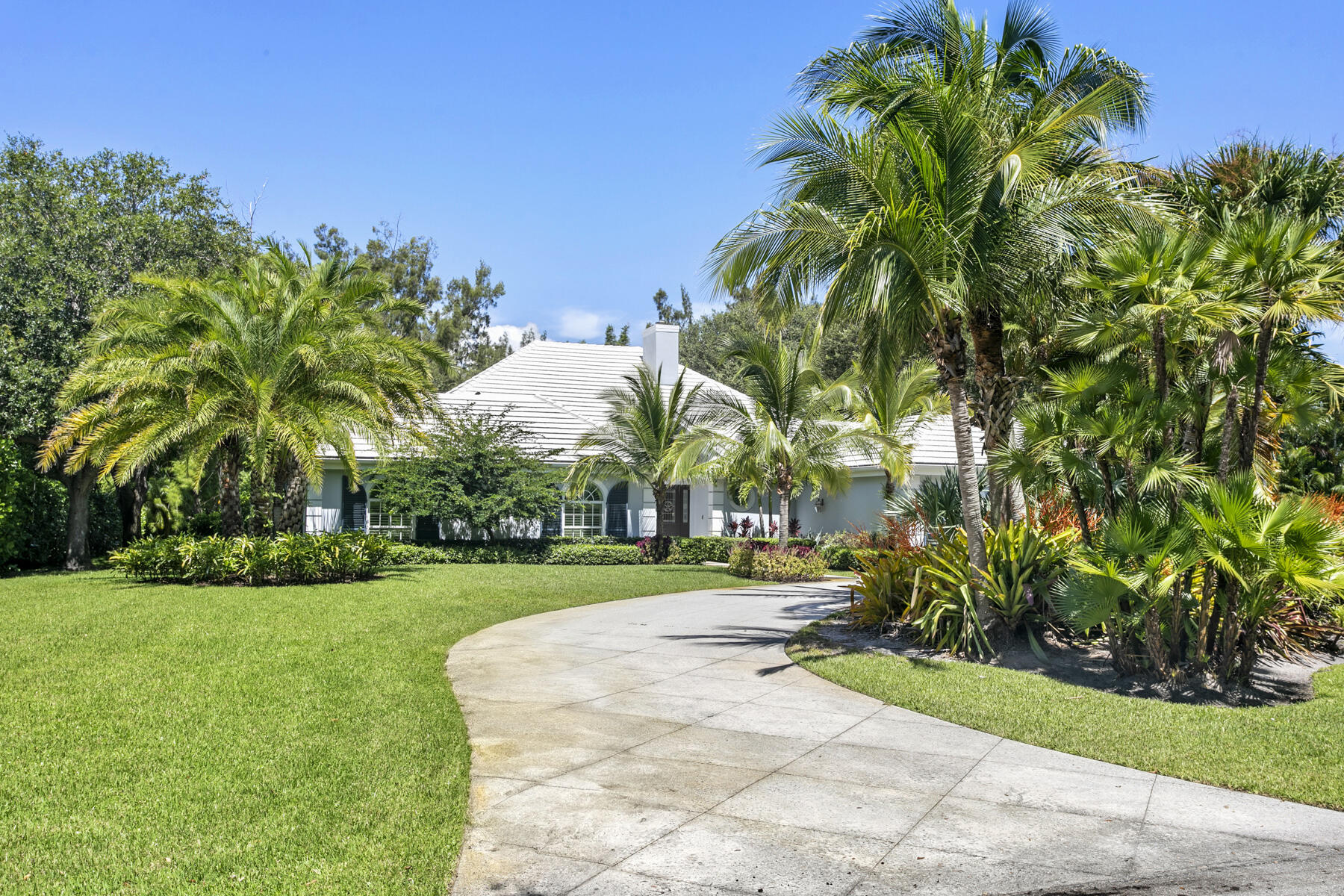5BD/3.1BA coastal contemporary home in exclusive Seminole Landing, a gated community with 24-hour security, private beach access, golf cart-friendly streets, and tennis courts. Nestled on a lush tropical 1-acre lot, this 3,952 sq ft home has vaulted ceilings, impact windows, marble baths, and custom closets. The split floor plan includes 4 bedrooms and 2 baths in the family wing, plus a separate cabana suite opens to the outdoors, complementing the formal living, dining, and family rooms. Move-in ready luxury.